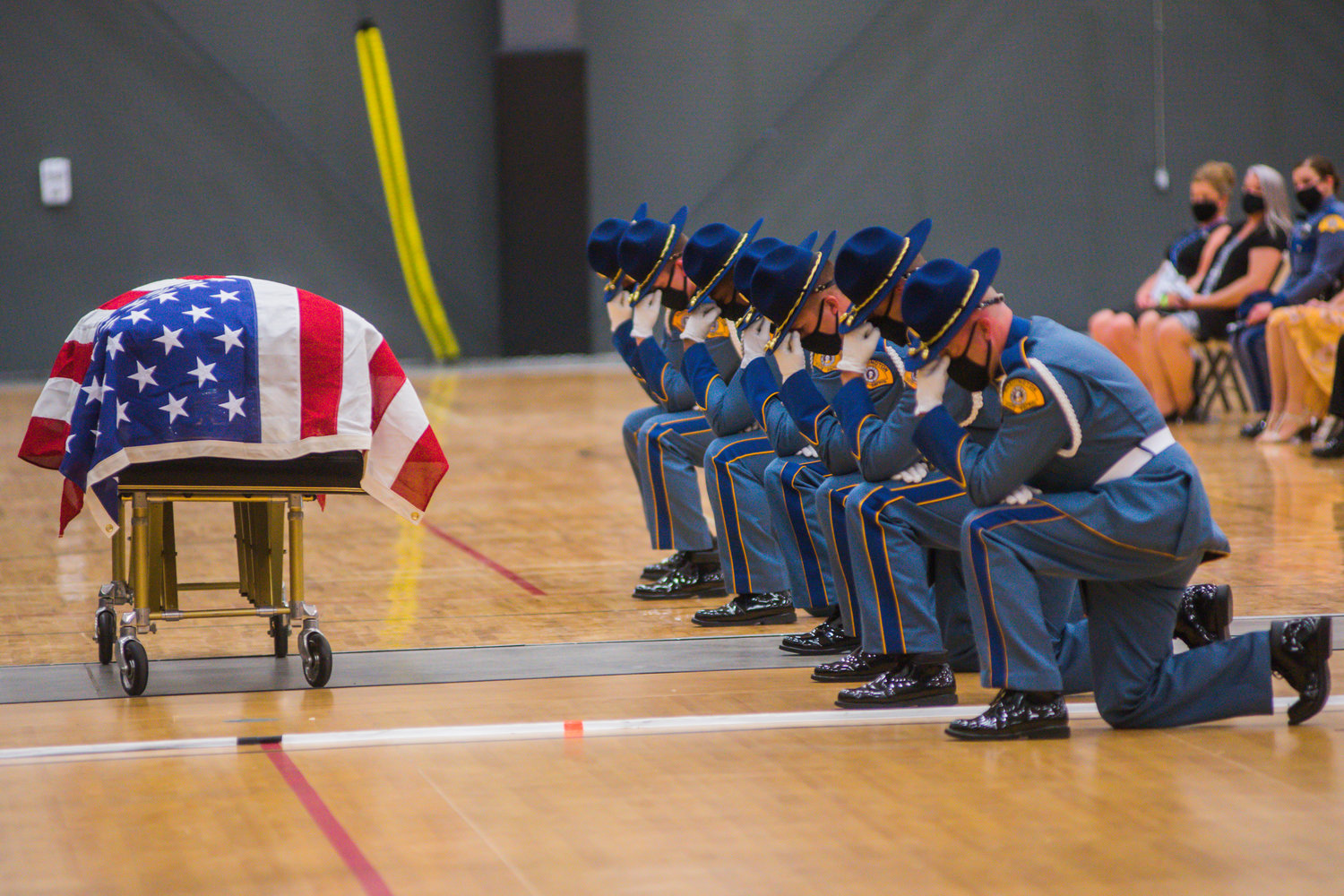 Members of the Washington State Patrol kneel at the casket of Justin R. Schaffer during a service to honor his life Wednesday afternoon in Centralia.