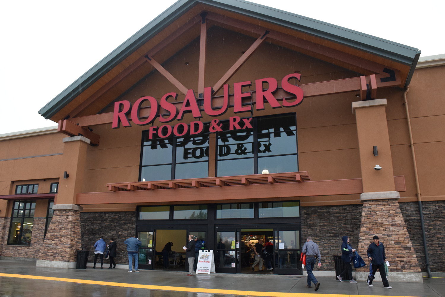 Customers come and go at the Ridgefield Rosauers, which had a grand opening Dec. 7. Grocery store workers are among the many taking on important roles amid the pandemic. 