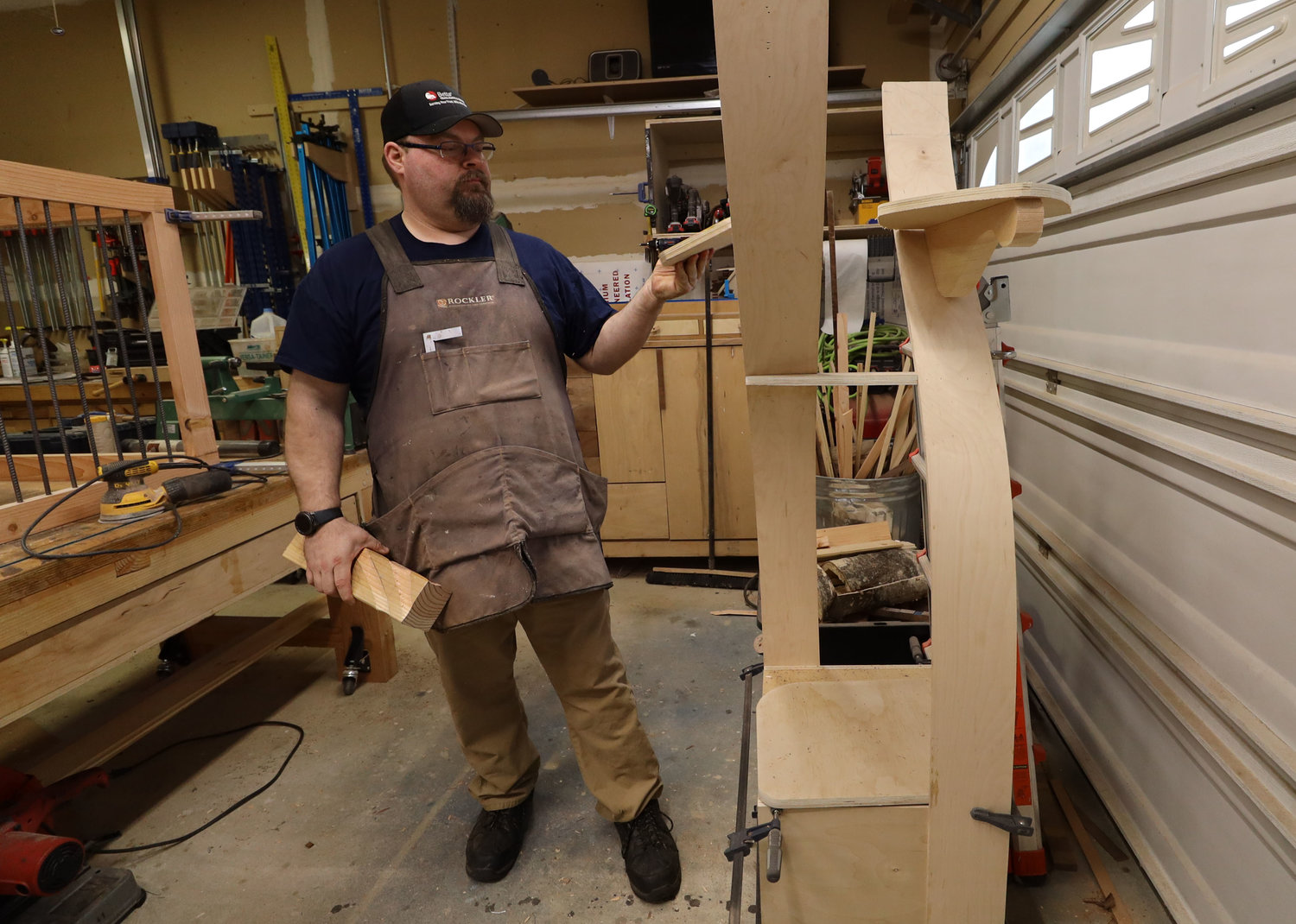 Woodworker Nathan Thompson places the steps for a cat tree at his in-home shop in Vancouver March 6.
