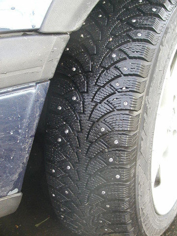 A studded tire is pictured.