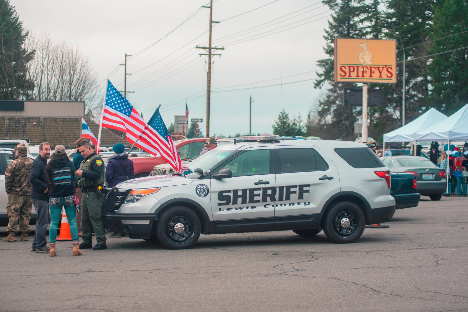 Lewis County Sheriff Deputies respond to a call at Spiffy’s after a car peeled out of the parking lot while surrounded by a group of ‘peaceful protesters’ on Thursday in South Chehalis.