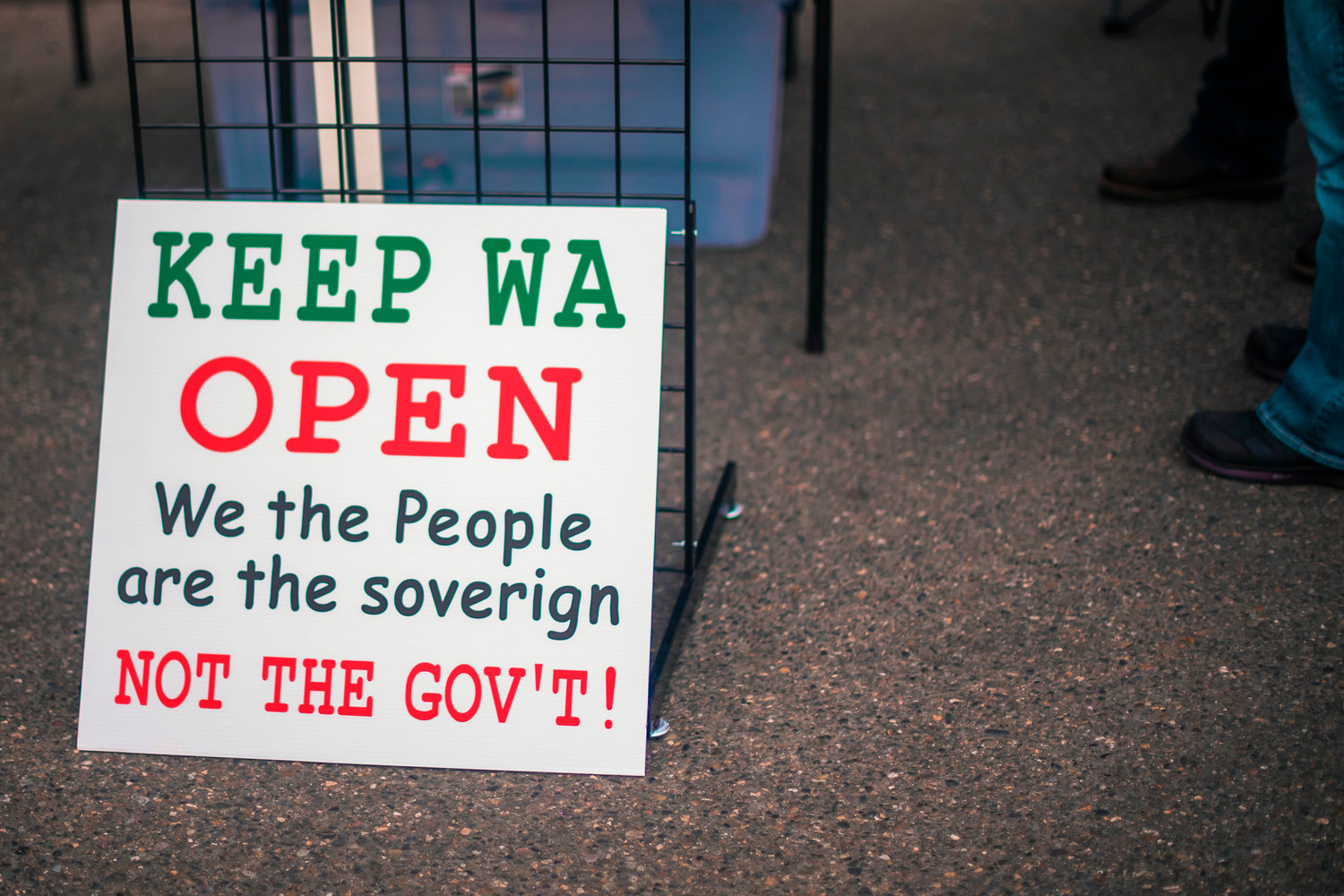A sign is displayed outside of Spiffy’s near a merchandise table reading, "Keep WA Open" as the restaurant continues to host indoor dining on Thursday in Chehalis.