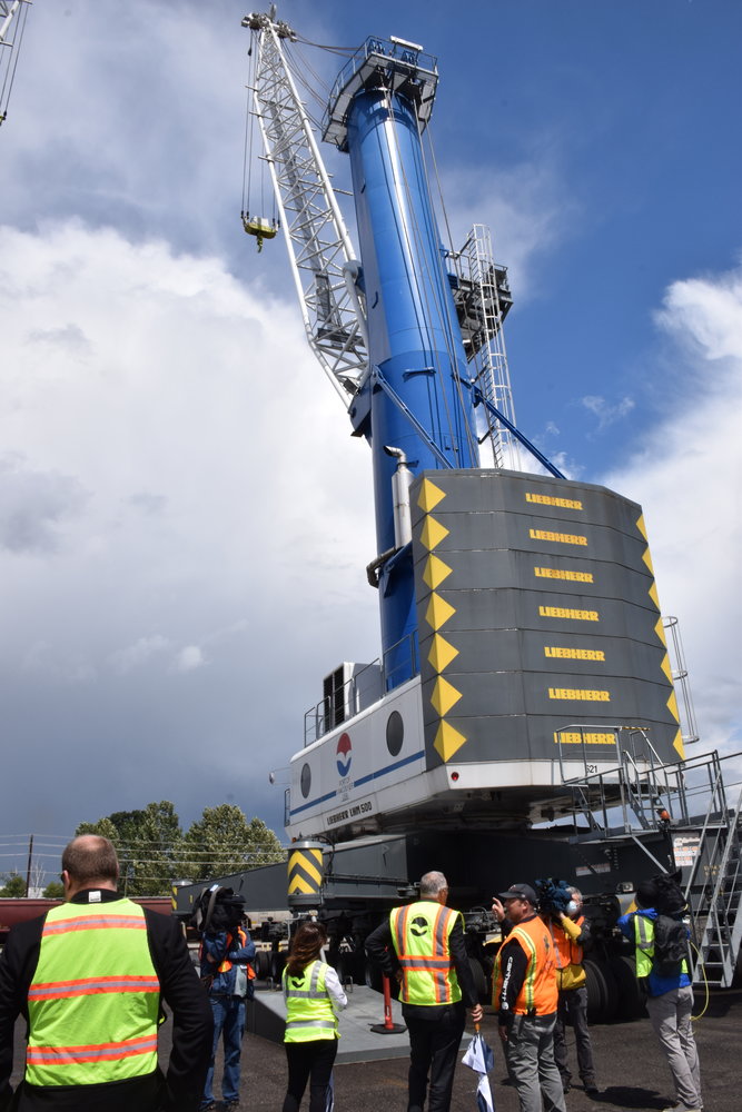 Gov. Jay Inslee and other local officials look at one of two cranes used to unload wind turbine components during the governor’s visit to the Port of Vancouver on June 15.