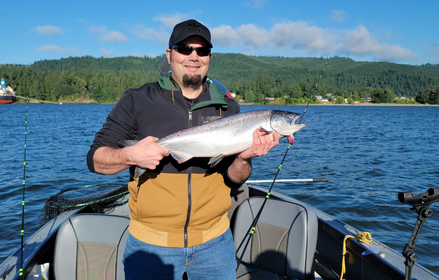 Eric Trent holds a spring-run Chinook salmon he caught on the Columbia River on June 18, 2021.