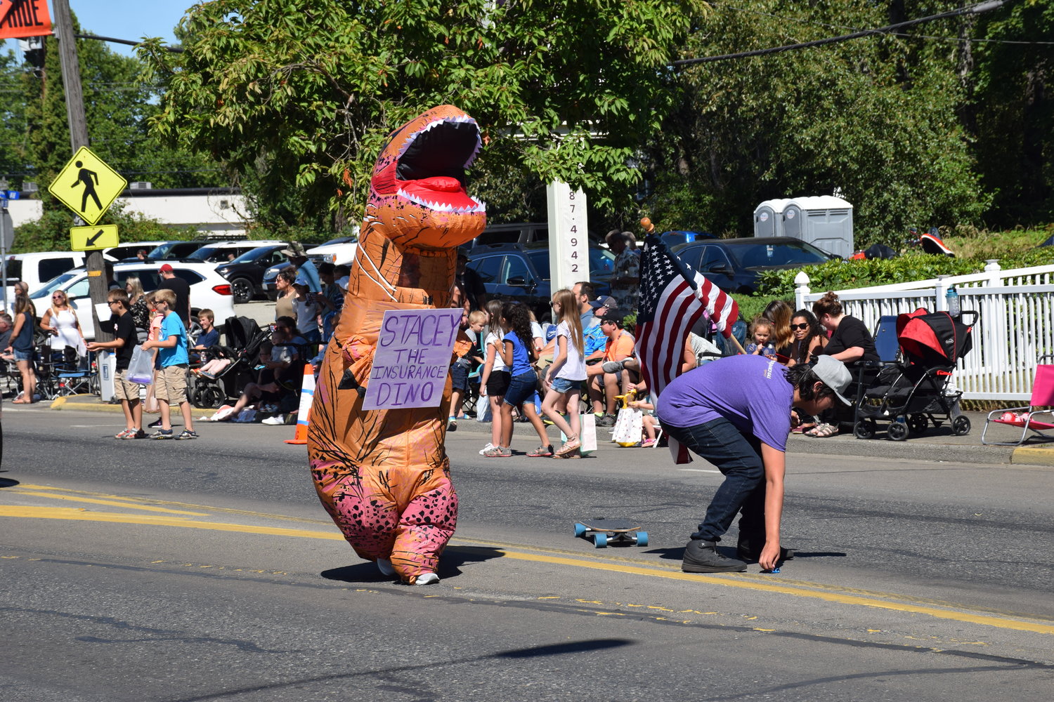 “Stacey the insurance dino” marches down Main Street during Battle Ground’s Harvest Days parade on July 17, 2021.