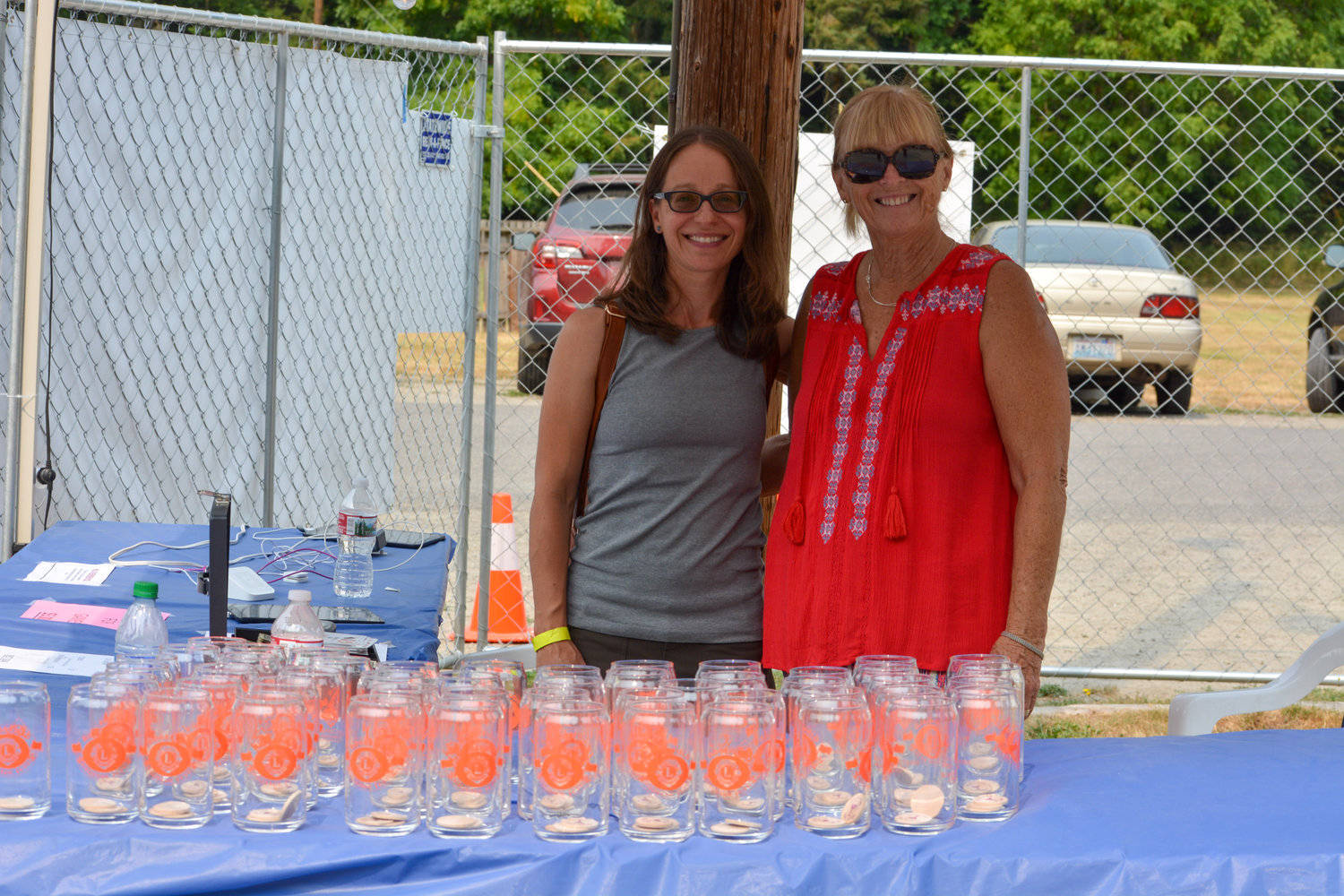 Volunteers pass out commemorative beverage glasses at the Ridgefield Sausage Festival on Aug. 14 at Abrams Park.