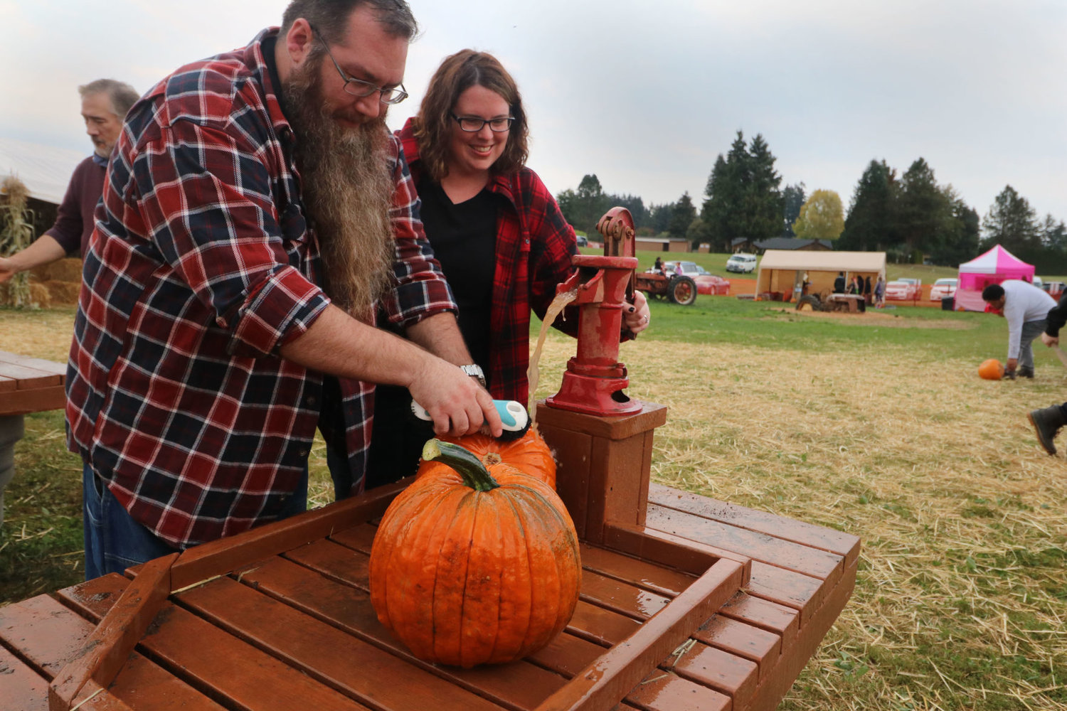 Avery (left) and Tracy Allen scrub off their pumpkins before taking them home at Bi-Zi Farms during their opening day in 2018.