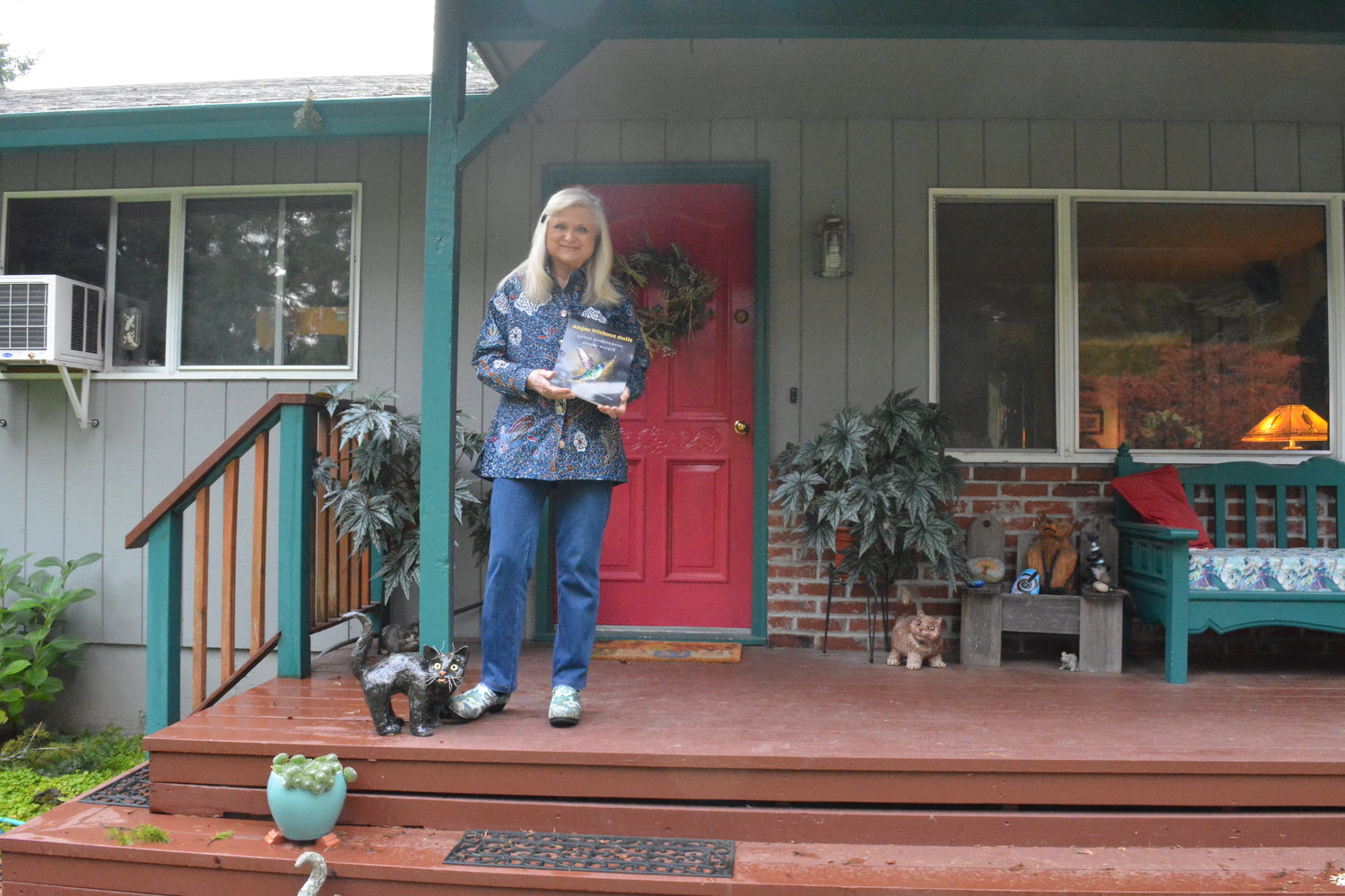 Dr. Gerry Dunne poses with her book Anger Without Guilt in front of her home in Battle Ground.