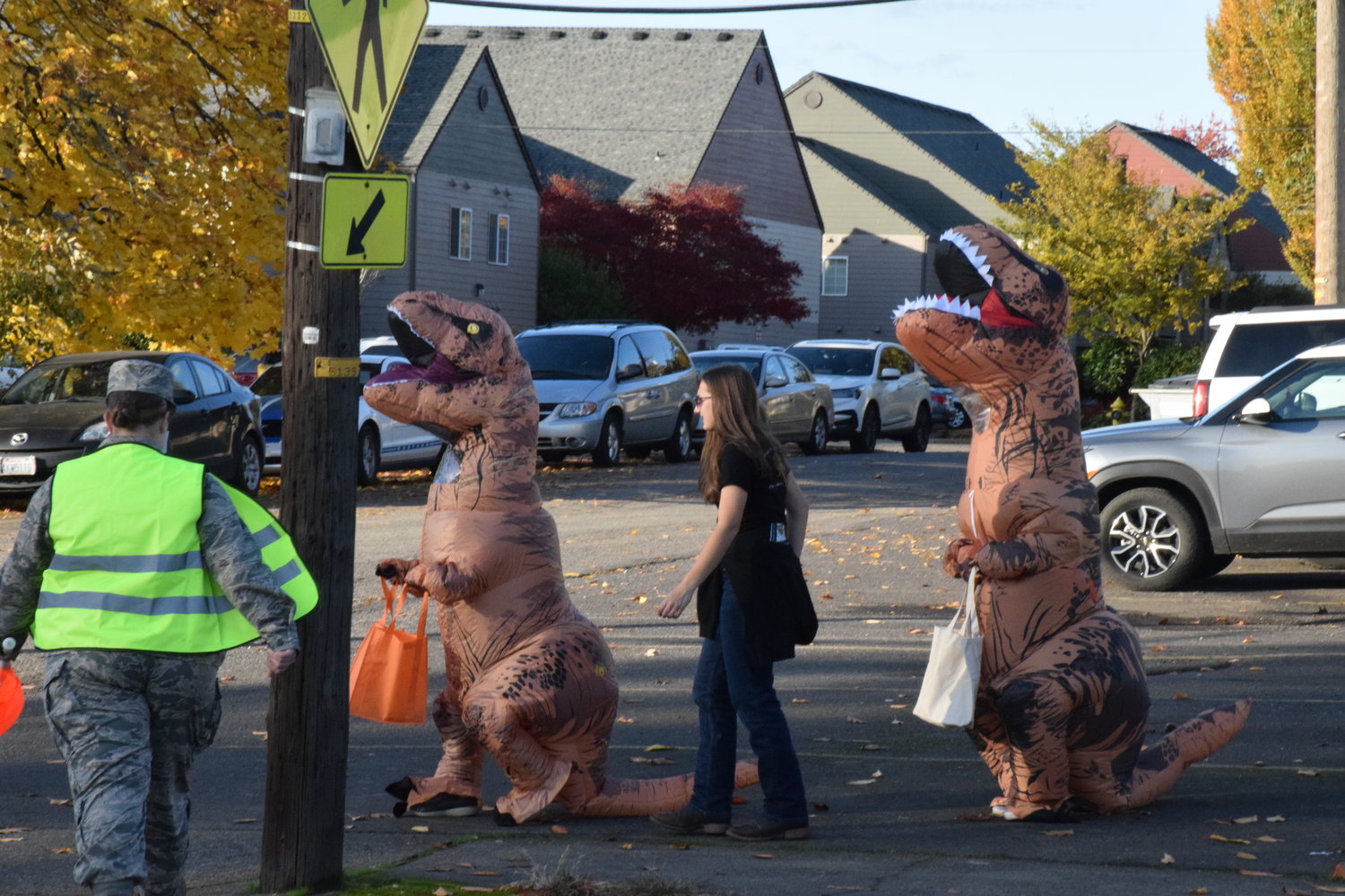 Tyrannosauruses head down Main Street in Battle Ground during the city’s annual Halloween event on Oct. 29.