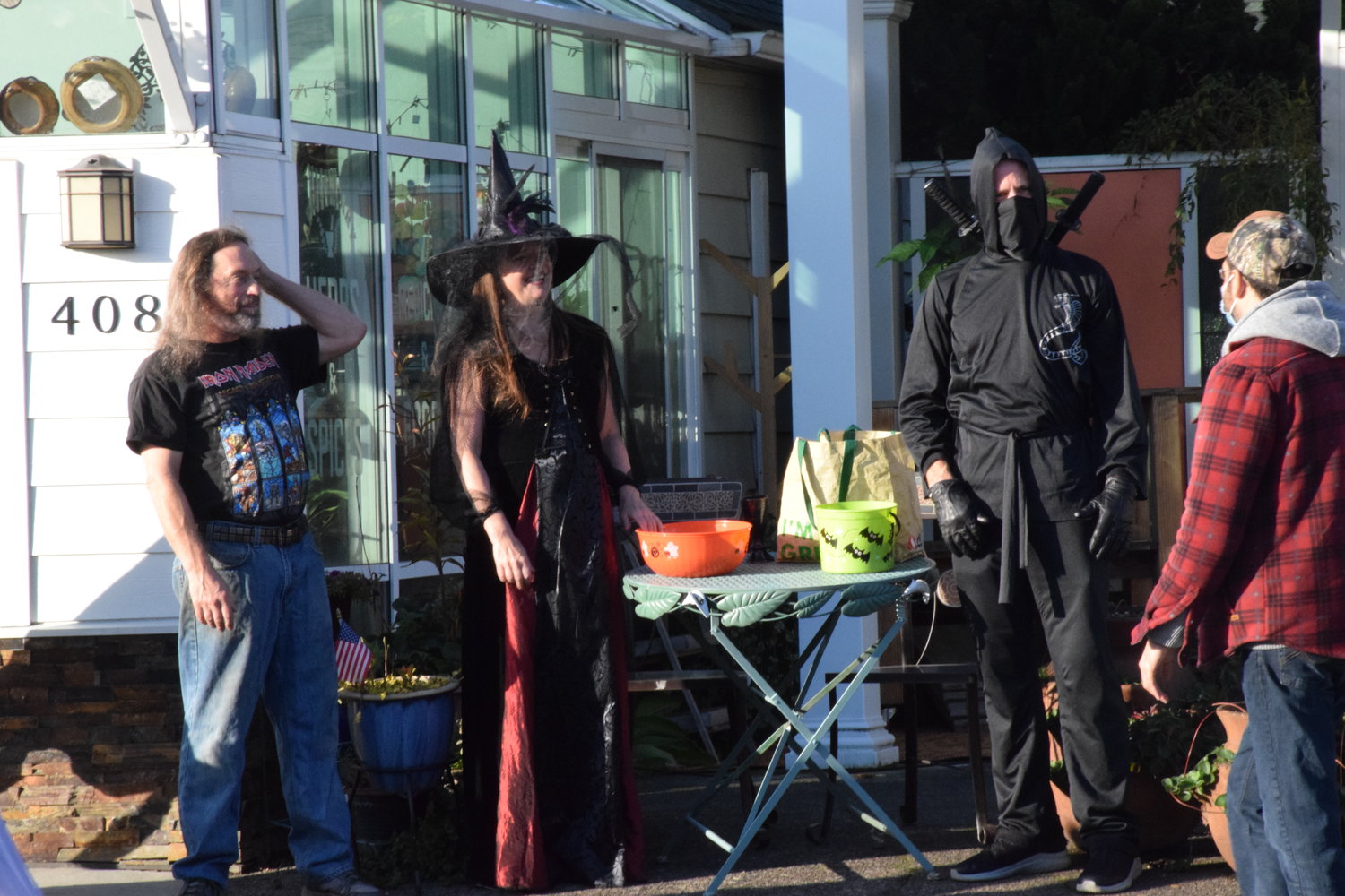A ninja, a witch and a heavy metal fan at Battle Ground Healing Arts pass out candy during the city’s trick or treat trail event on Oct. 29.