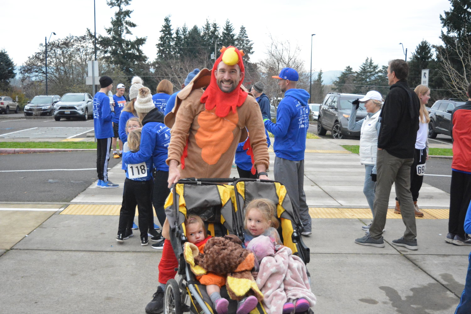 Kyle Simmons wears a turkey costume, with his two daughters in a stroller, during the annual Turkey Trot on Thursday, Nov. 25.