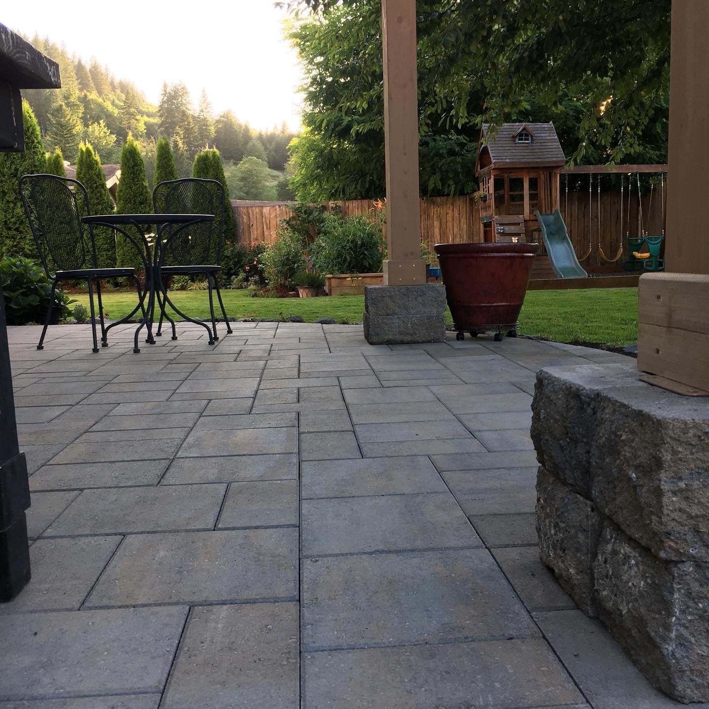 A stone back porch patio that Woody’s Custom Landscaping built is pictured.