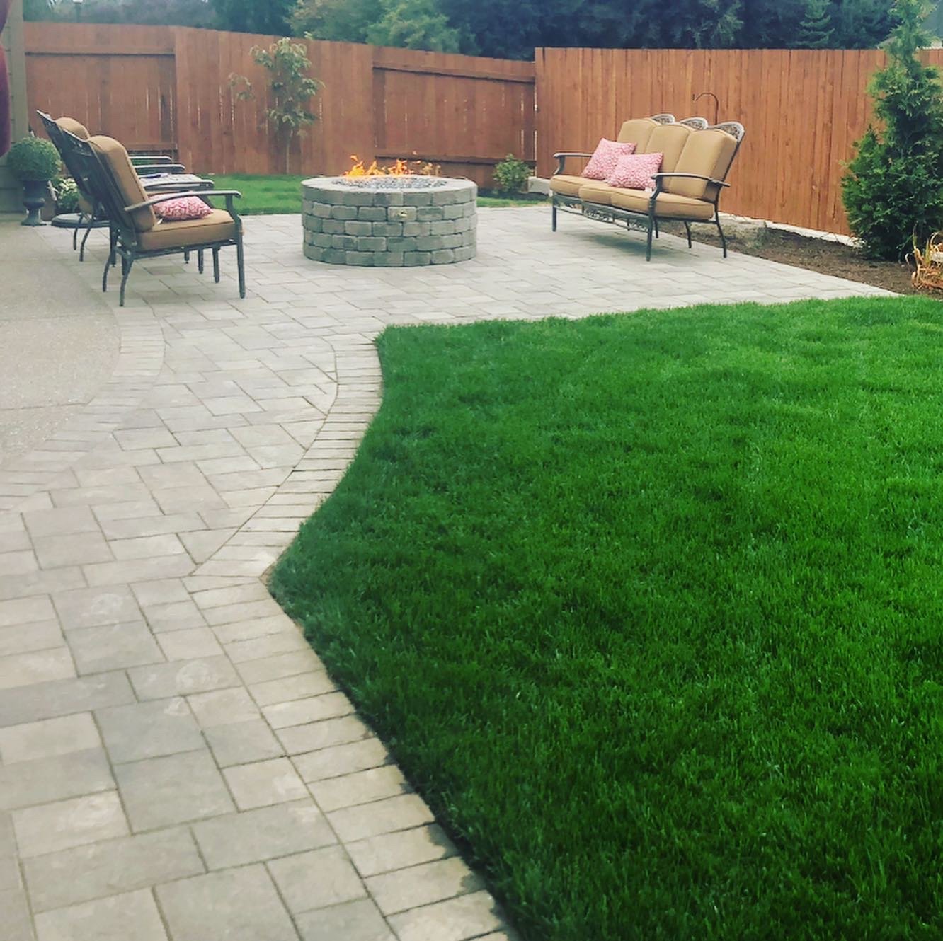 A patio and lawn completed by All American Landscaping & Maintenance is pictured.