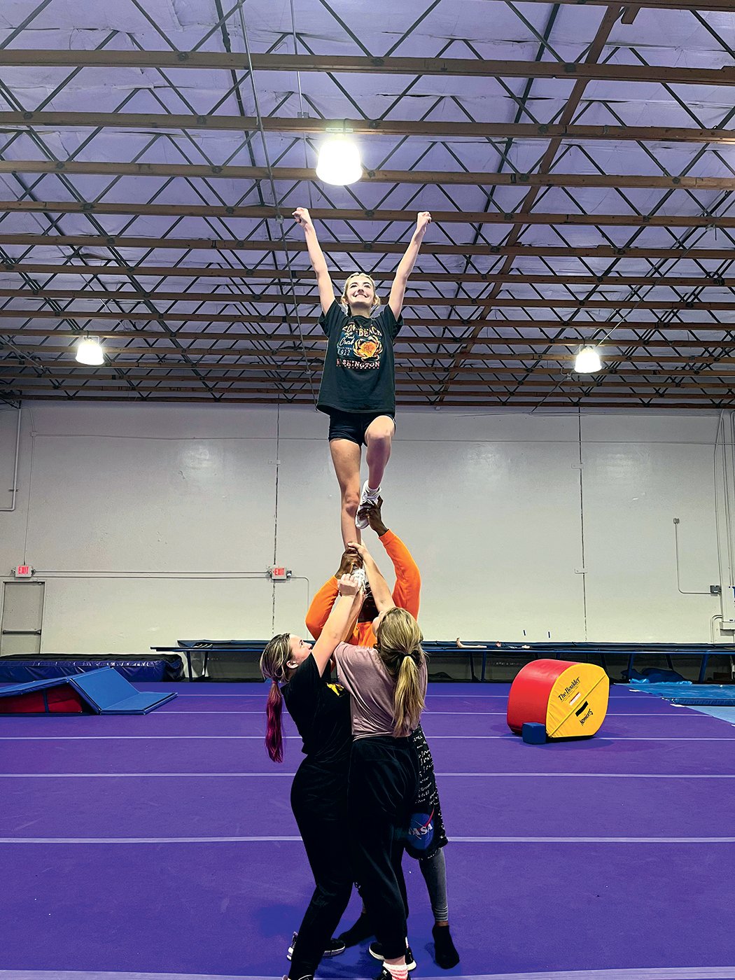 A group of cheerleaders form a tower at Cosmic Cheer.