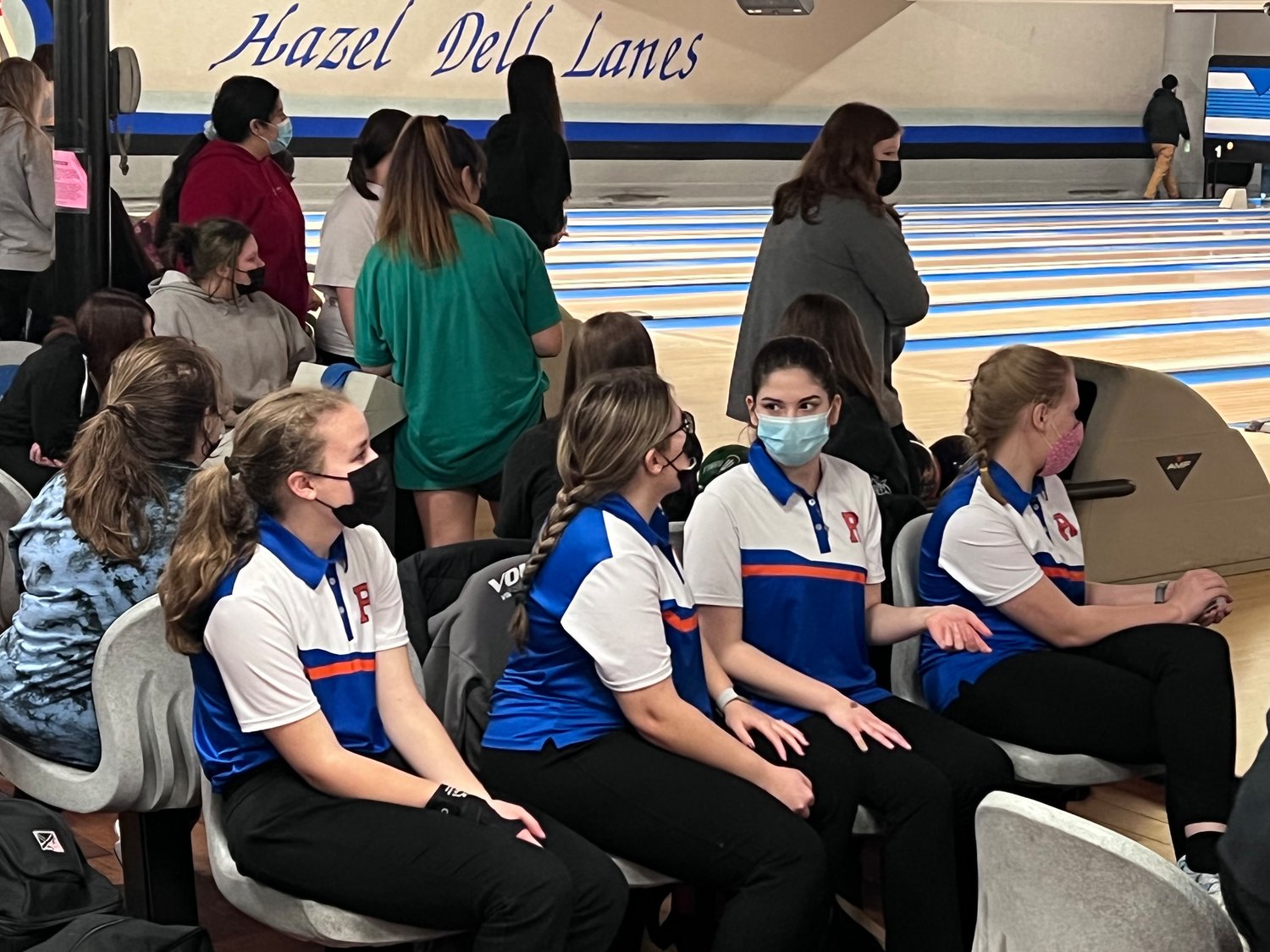 A group of Ridgefield bowlers watch their teammate play.