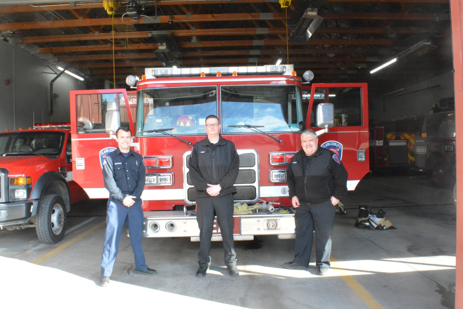 photo by Sebastian Rubino
Josh Haldeman, Sam Lewis, and Mike Jackson, all from Clark-Cowlitz Fire Rescue, are pictured in front of fire engine 26.