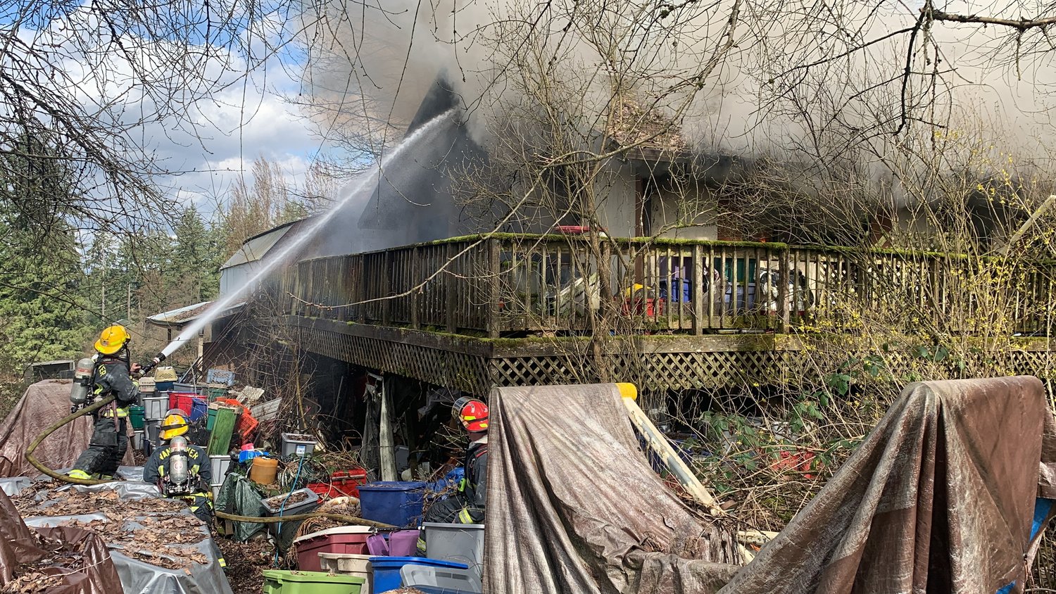 Firefighters undertake a defensive attack at a house fire in the Cherry Grove area on March 16. 
