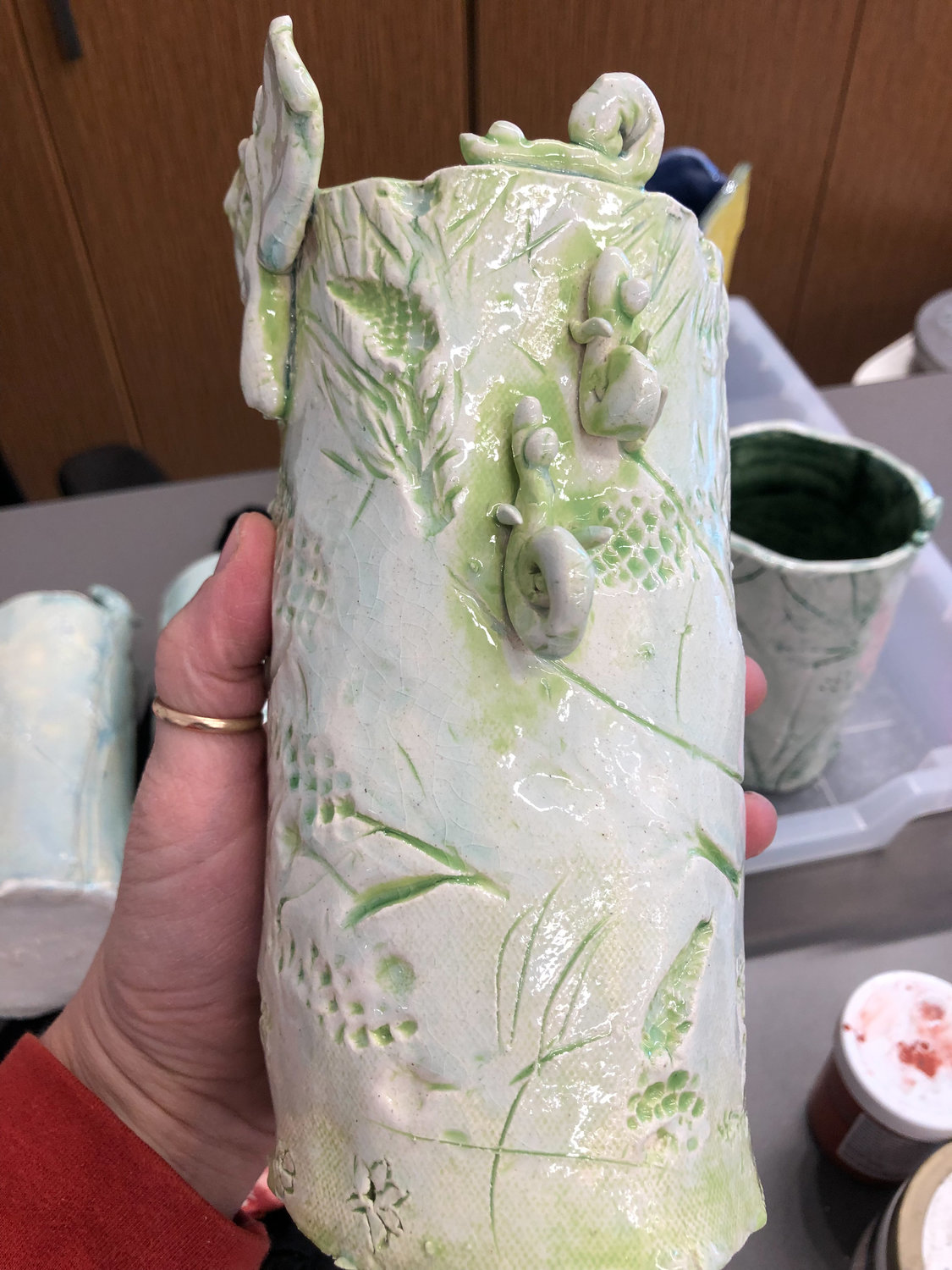 A vase made by a student at View Ridge Middle School uses weeds and branches as an imprint.