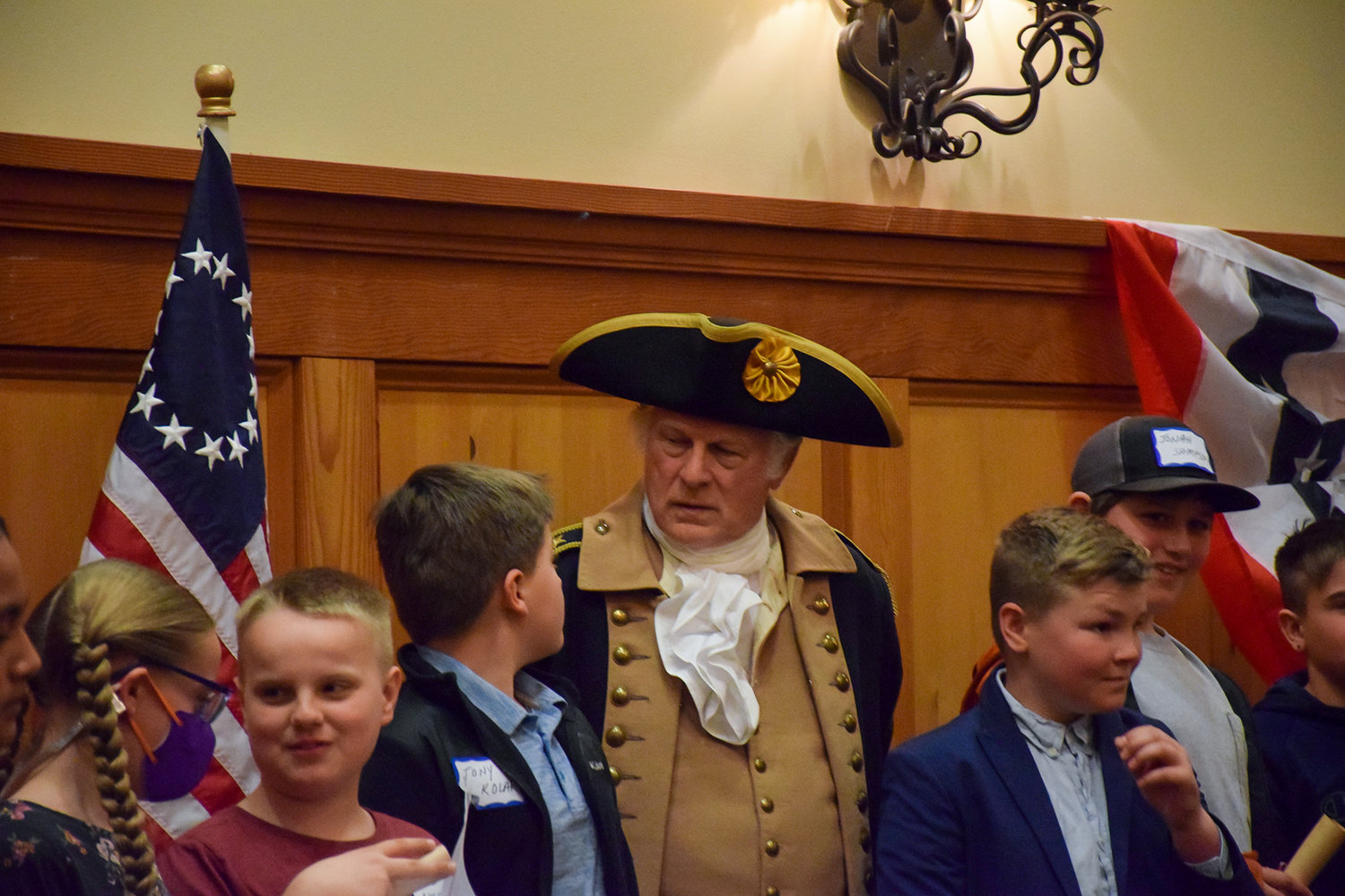 George Washington reenactor Vern Frykholm takes photos with Tukes Valley Middle School students during the Sons of the American Revolution convention at the Heathman Lodge on April 9.