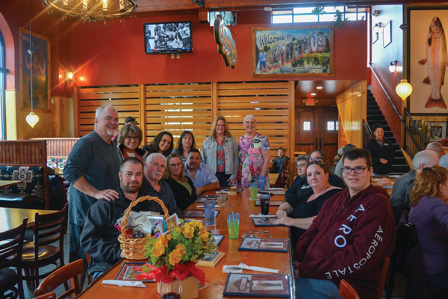 Tyler Mode, far left, sits with his family at the Northwood Public House and Brewery on April 16 after he received Battle Ground’s Citizen of the Year award.