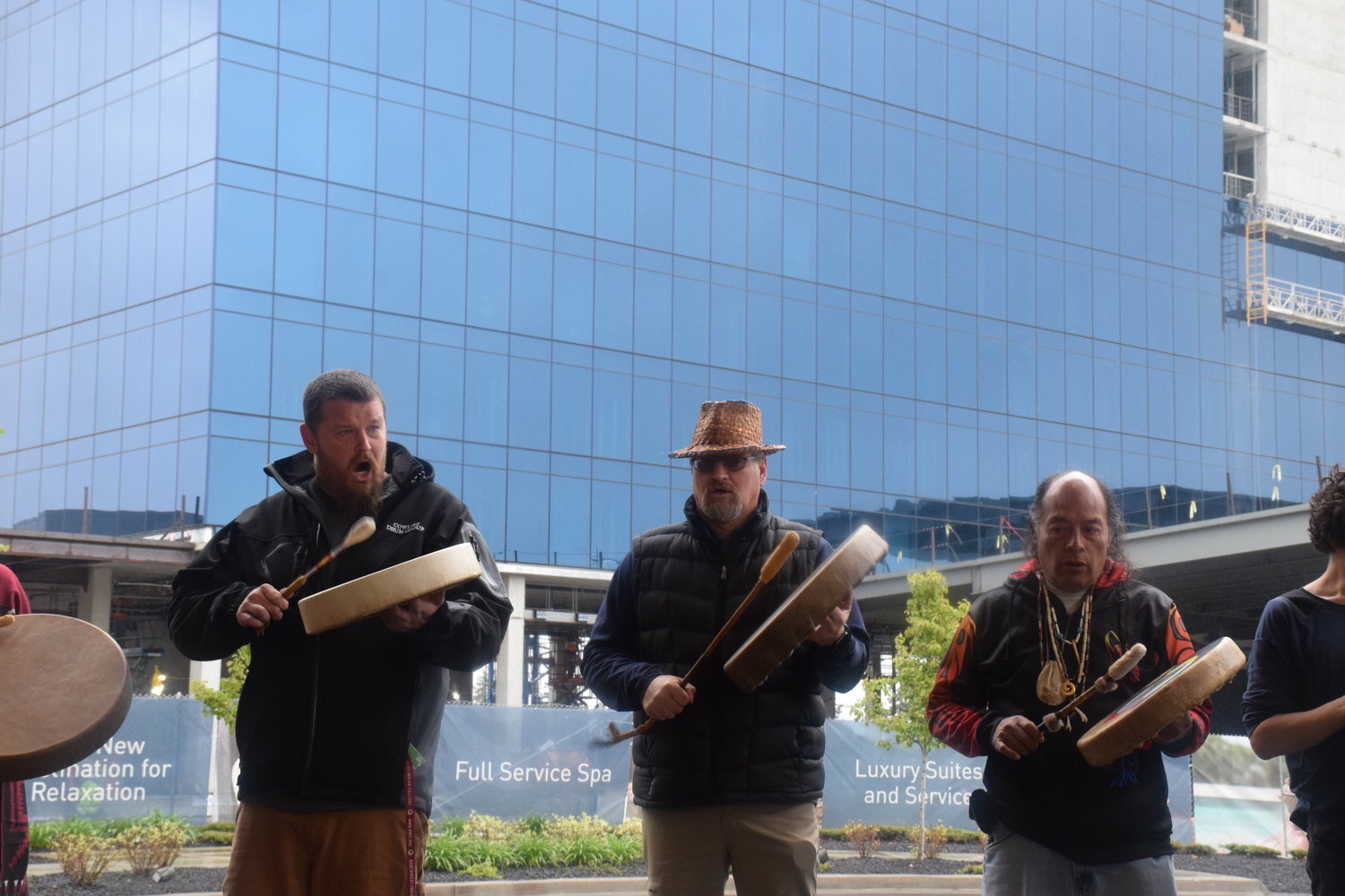 Cowlitz Indian Tribe Drum Group drummers perform in front of the under-construction ilani luxury hotel during a five-year anniversary celebration of the casino resort April 25.