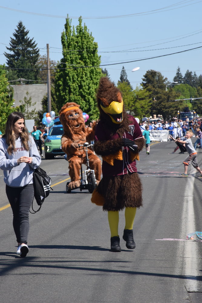 Rally the Raptor and a Sasquatch participate in the Parade of Bands on May 21 as they march down Hazel Dell Avenue.