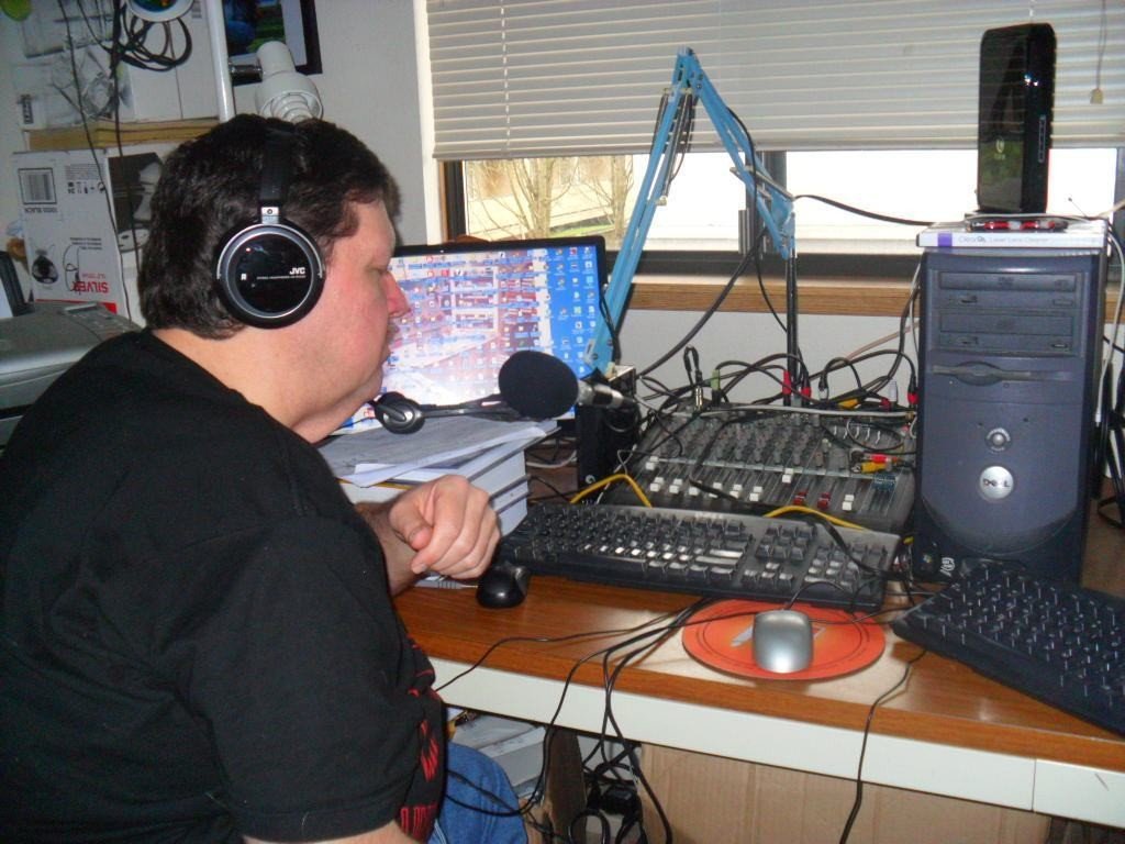 Gerald Gaule talks into the microphone at his radio station, Community Growth Radio, in Vancouver.