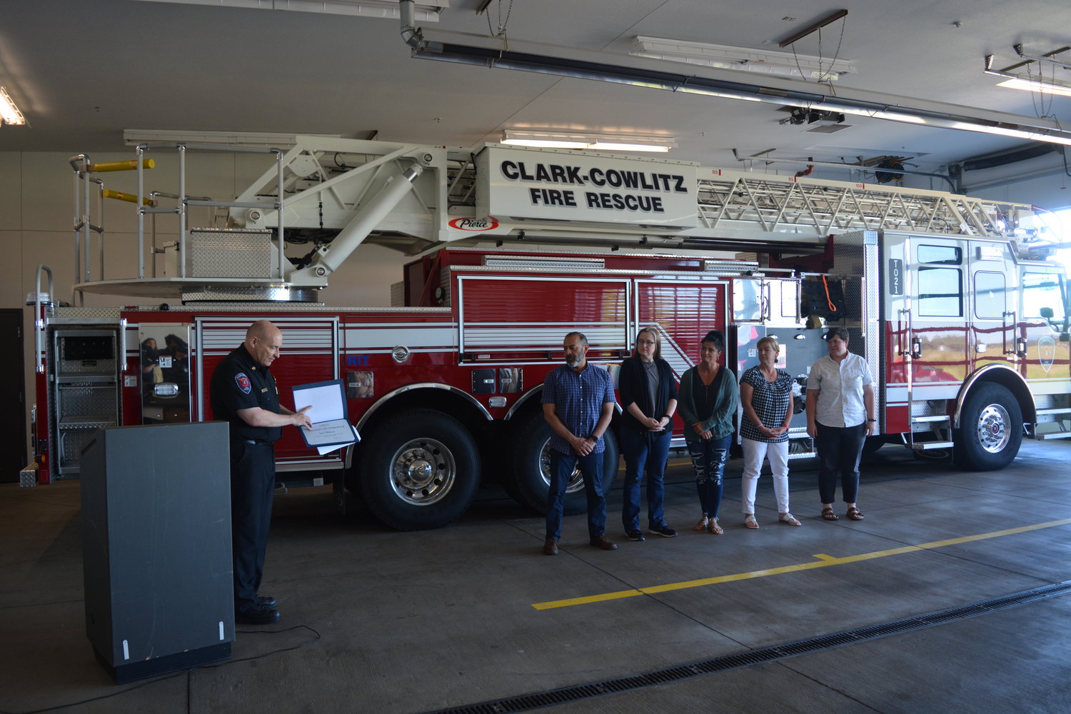 Clark-Cowlitz Fire Rescue Chief John Nohr recognizes staff at La Center High School for saving a student’s life during a ceremony at the station on June 23.