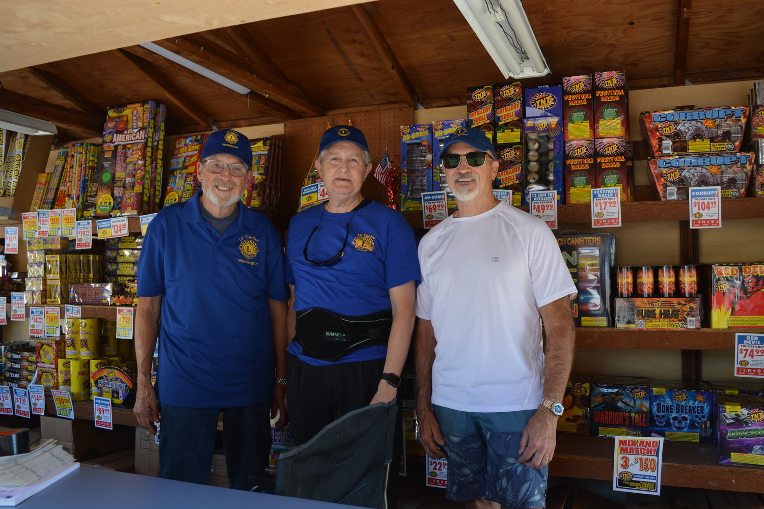 From left to right, Lions Club members Jim Irish, Lance Ebarb and Chris Kroll man their fireworks stand in La Center on June 29.