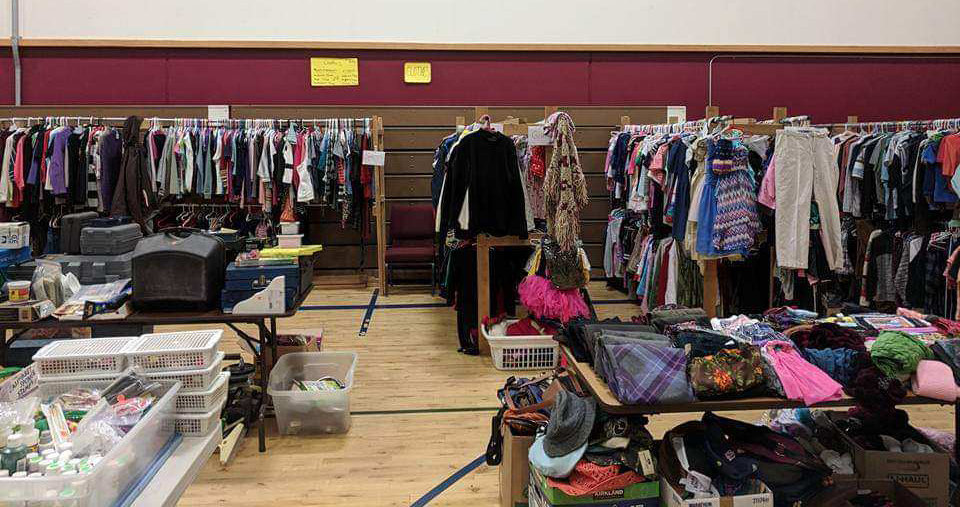 Racks of clothes are laid out at a previous rummage sale at Firm Foundation Christian School in Battle Ground.
