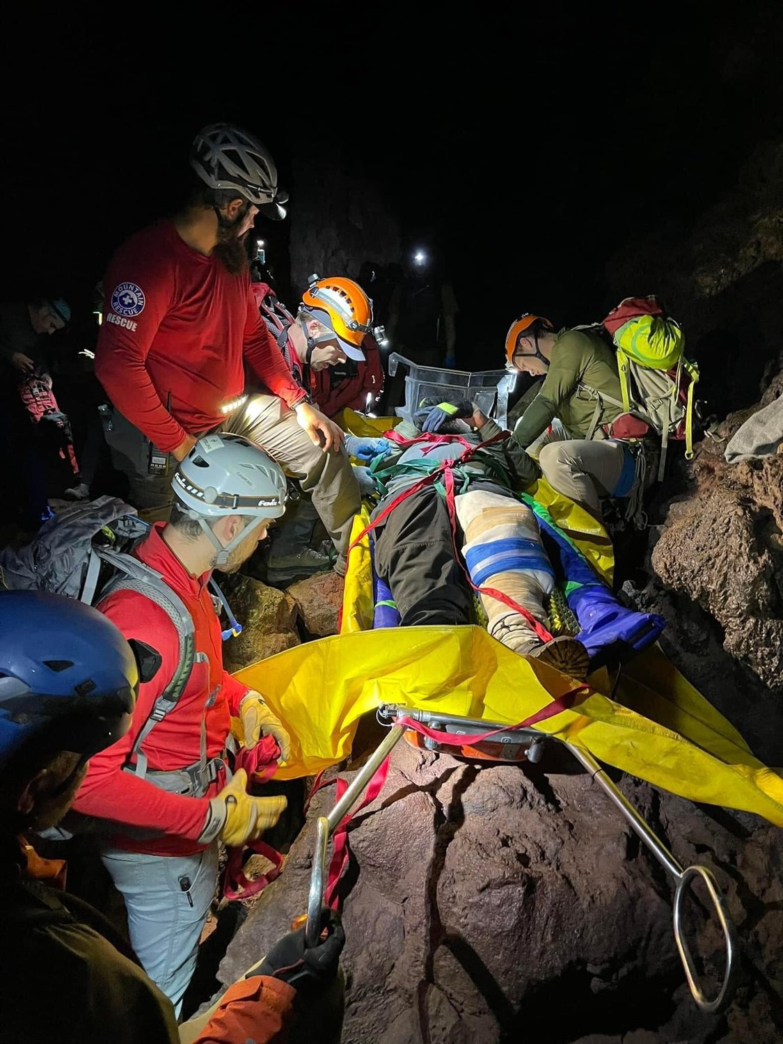 Volcano Rescue Team volunteers maneuver an injured climber out of the Ape Cave in this photograph published on Facebook.