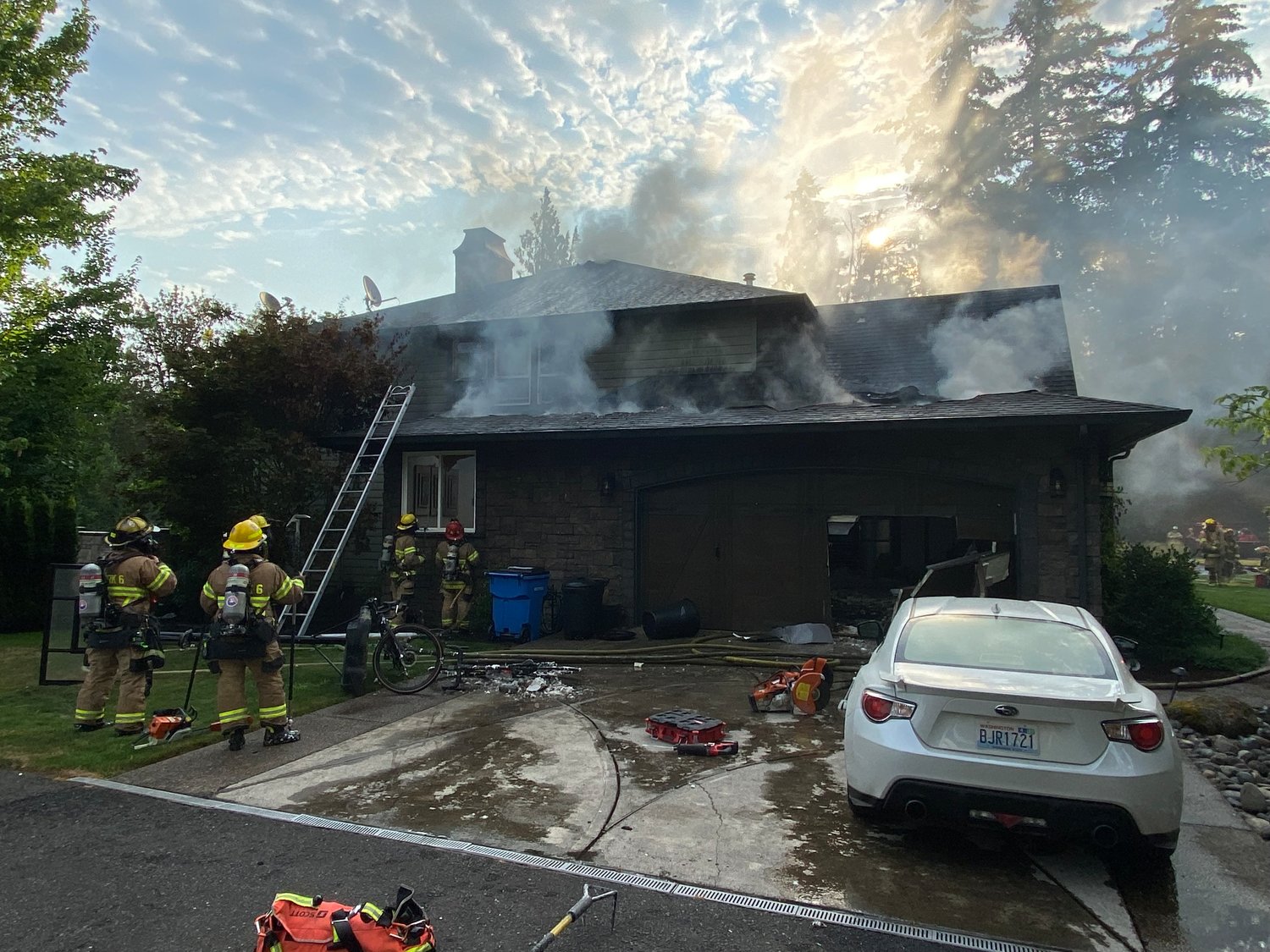 Firefighters work to extinguish a structure fire at a home in the 1400 block of Northwest 304th Circle in Ridgefield on Aug. 1. 