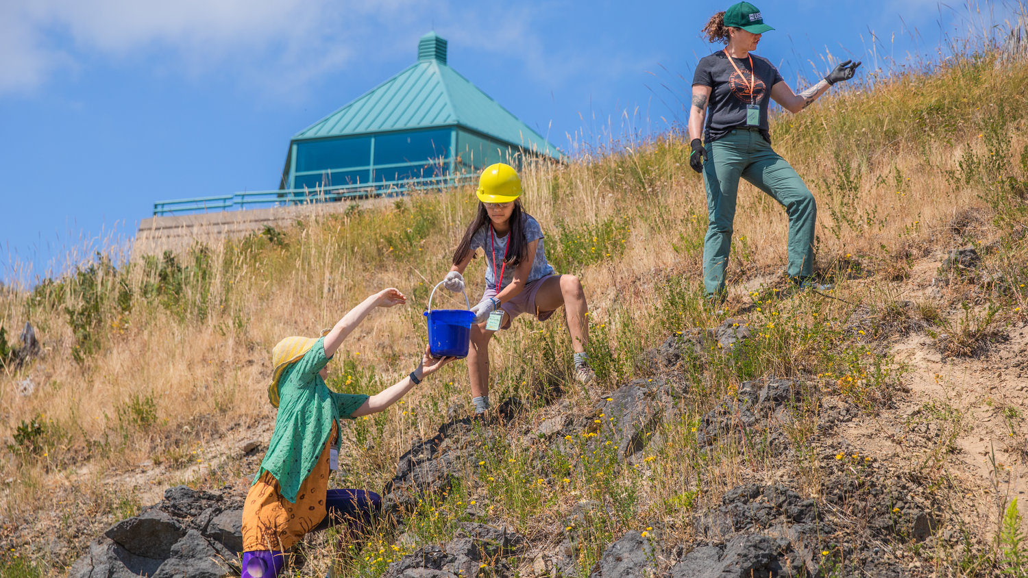 Mud is passed uphill during a GeoGirls project at the Mount St. Helens Science and Learning Center at Coldwater.