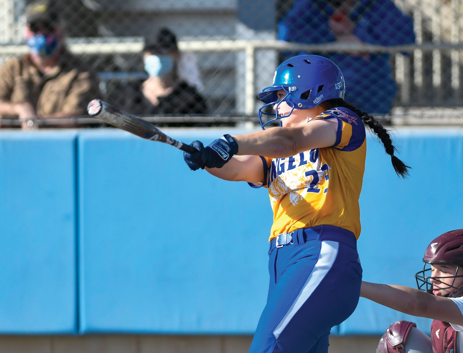 Maleya Burns hits a ball at a softball game for Angelo State University.