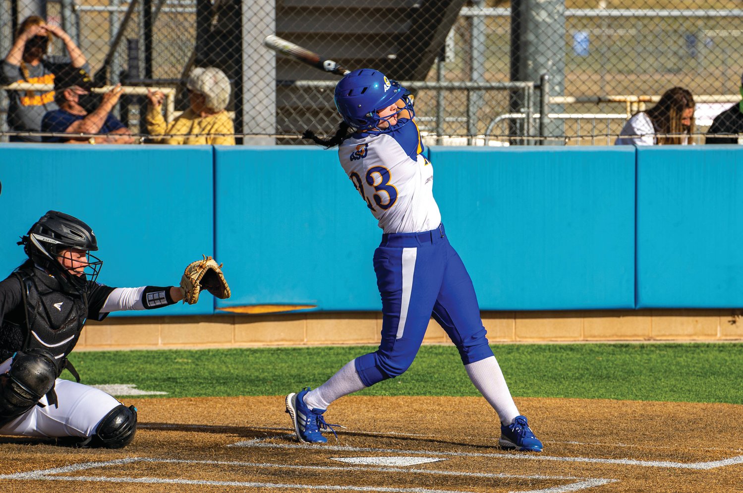 Maleya Burns hits the ball out into the field at a game for Angelo State University.