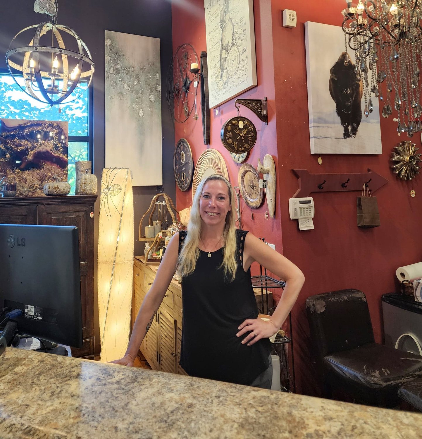 Rare Earth Decor manager Kolby Collins stands behind the counter at the store in Ridgefield.