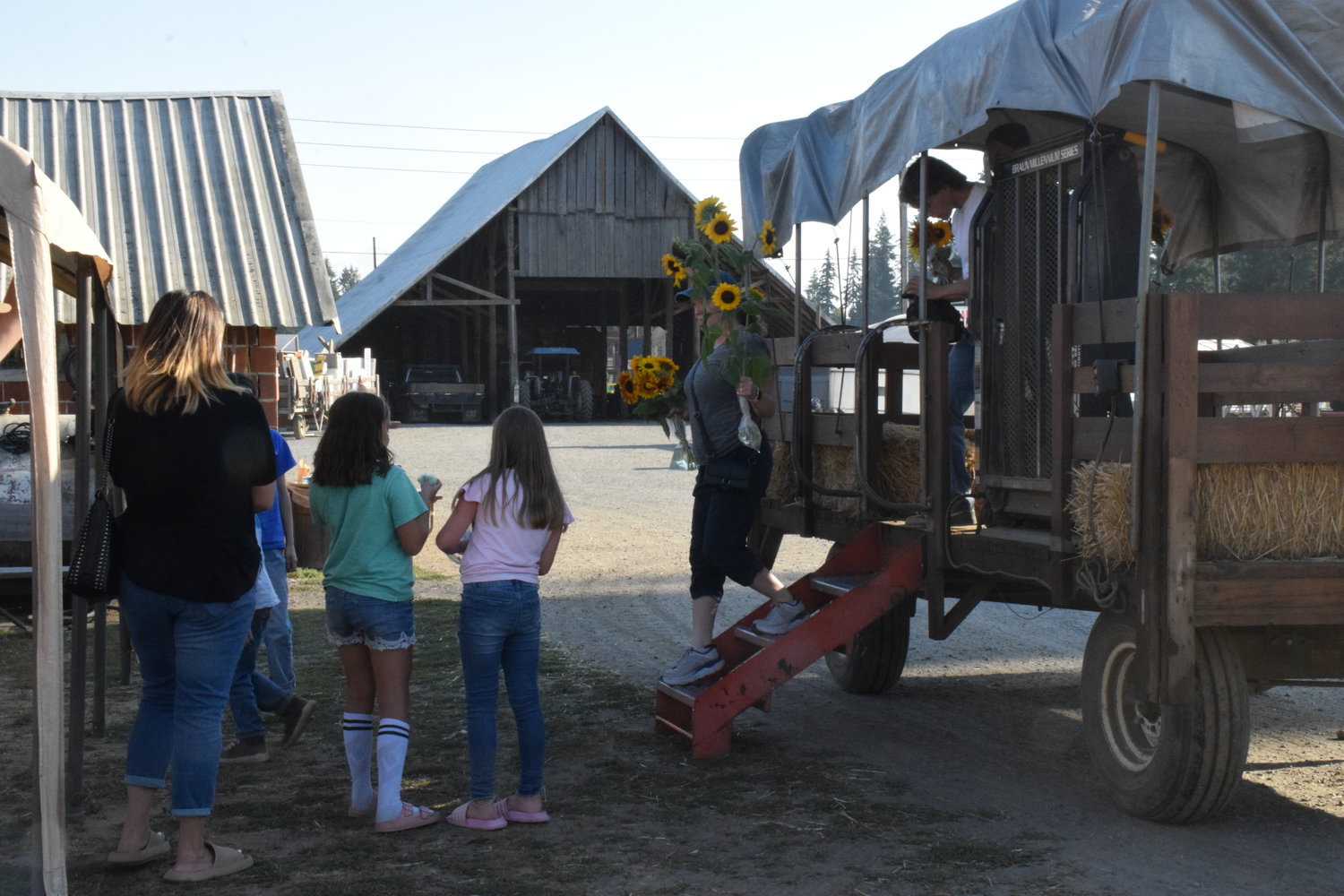 Visitors to Bi-Zi Farms wait to take a hayride at the farm on Sept. 9.