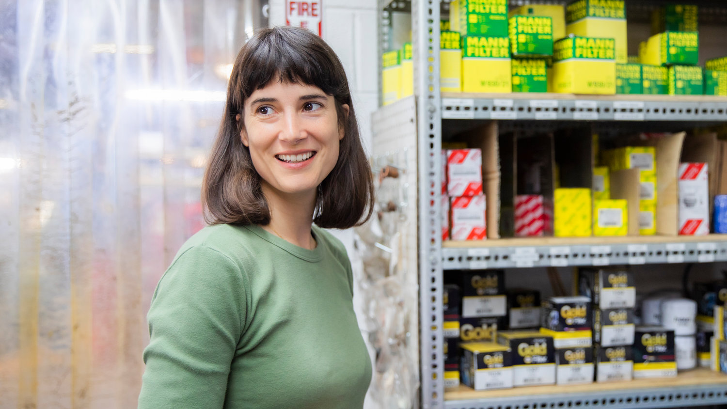 Marie Glusenkamp Perez smiles while pointing out organized shelves during a tour of Dean's Car Care, INC. in Portland on Thursday, Sept. 8, 2022.