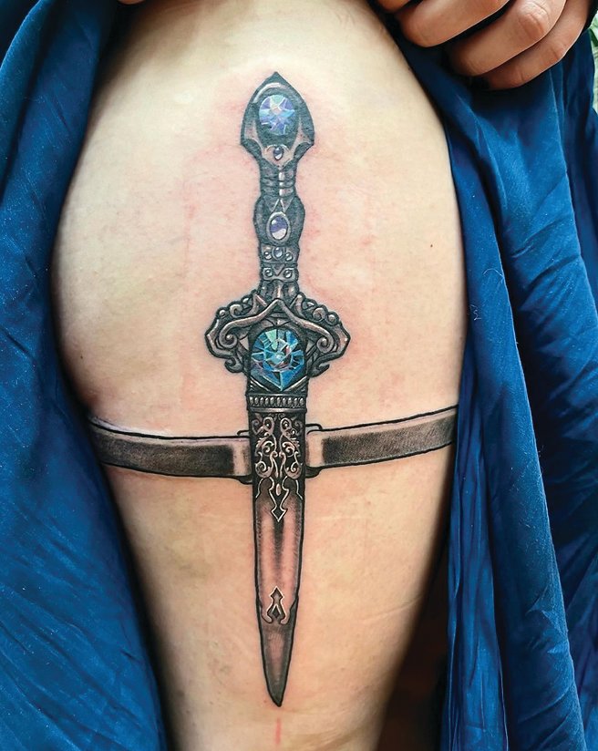 A medieval dagger tattoo done by Chelsea Stowers.