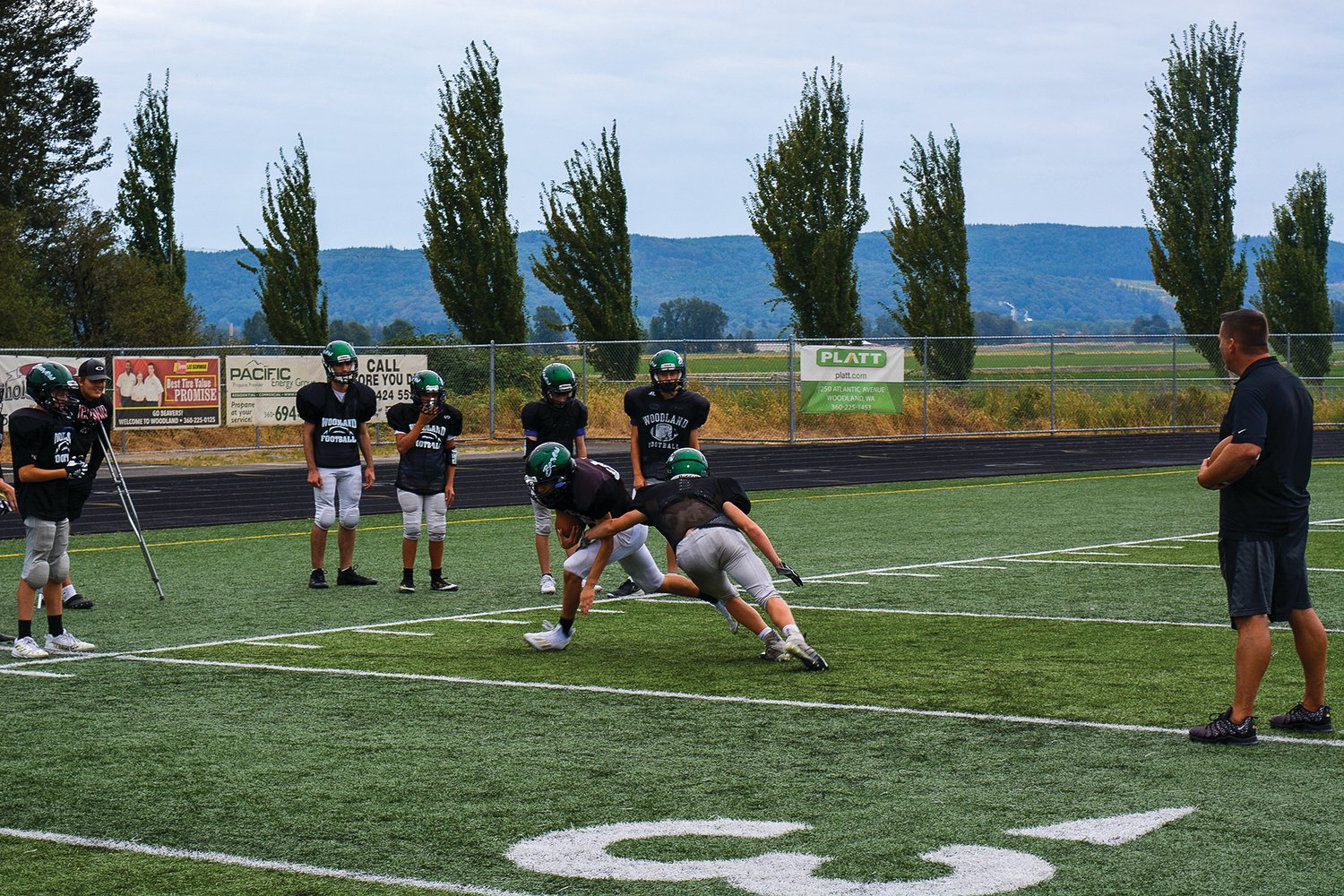 Woodland football players practice tackling on Sept. 13.
