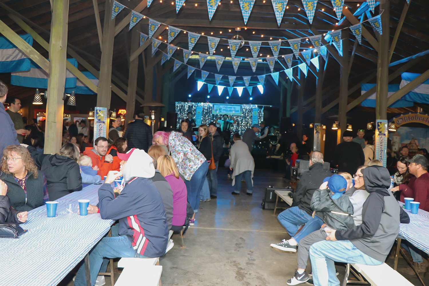 Families eat and drink at a previous Oktoberfest as the Smilin’ Scandinavians play.