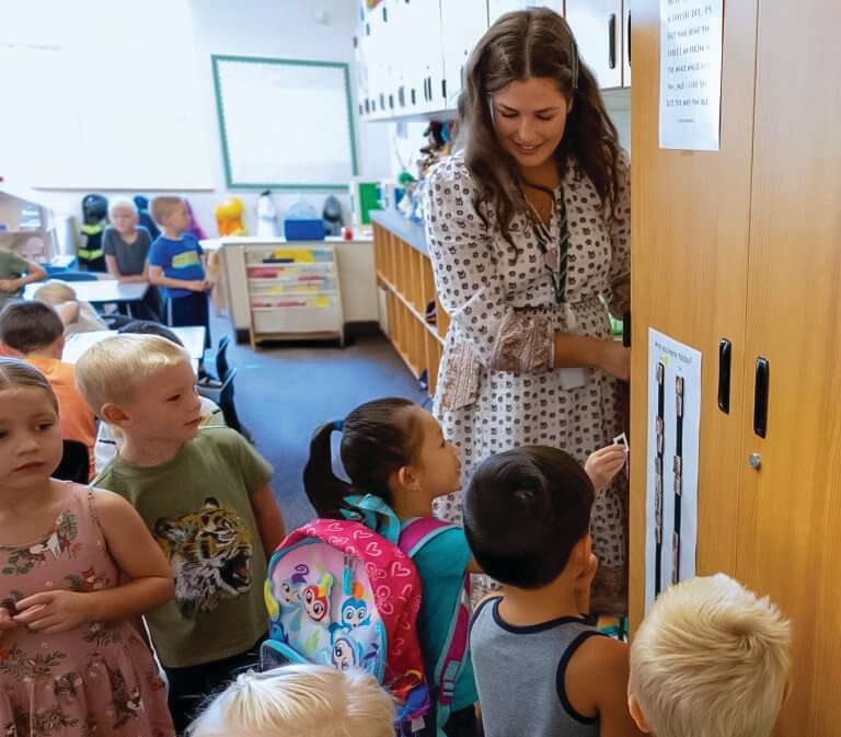 Gracelyn Crum, a transitional kindergarten teacher at Tukes Valley Primary School, greets her students.
