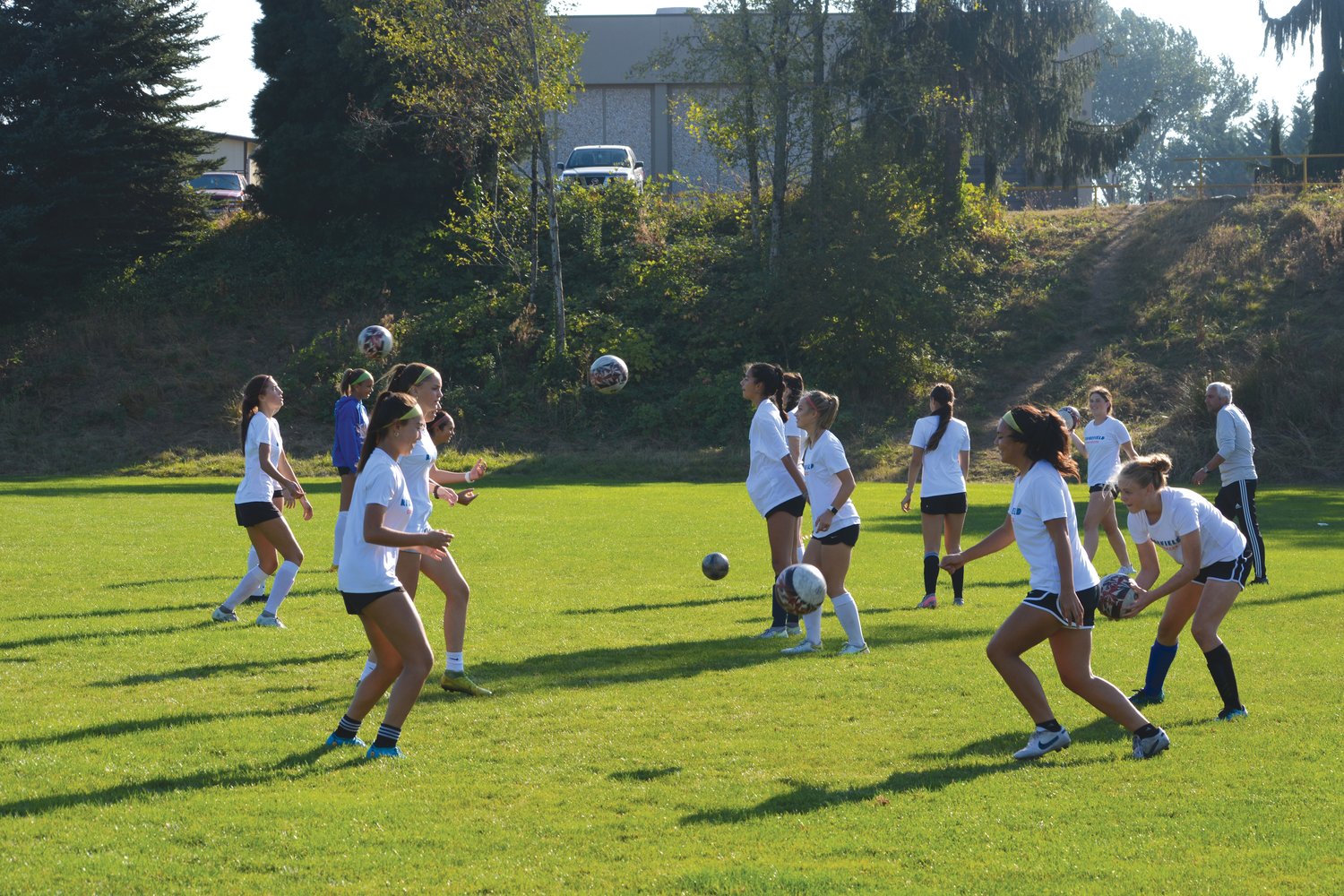Players from the Ridgefield Spudders girls soccer team toss the ball to each other on Oct. 5.