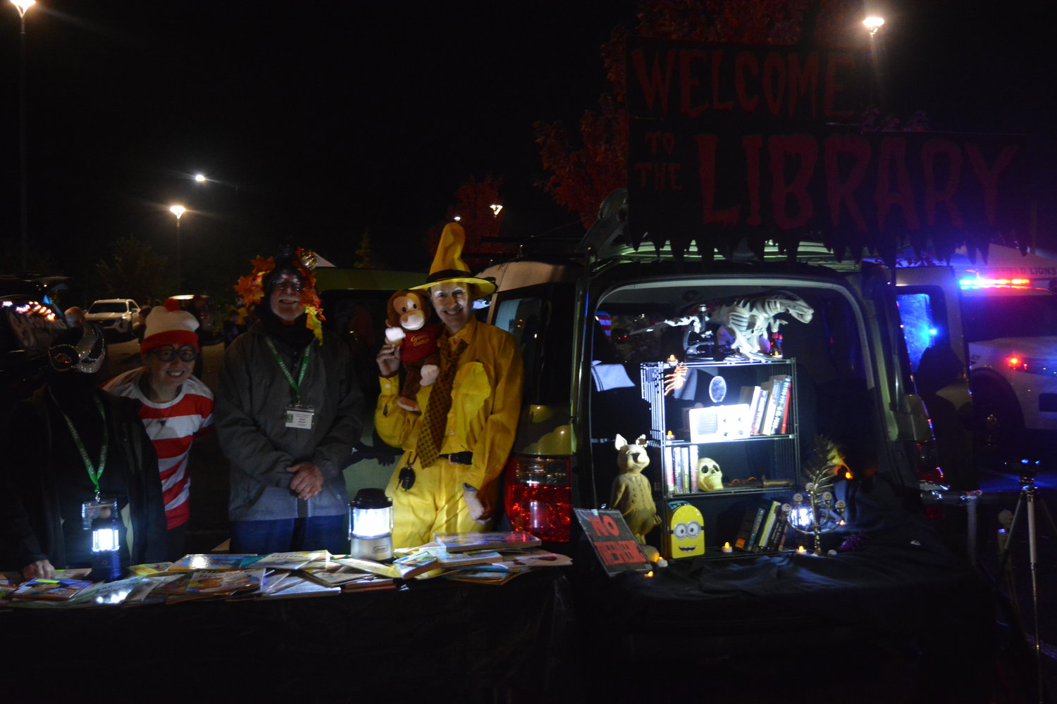 Volunteers with the Friends of Ridgefield Community Library show off their table of books at a trunk or treat event in Ridgefield on Oct. 29.