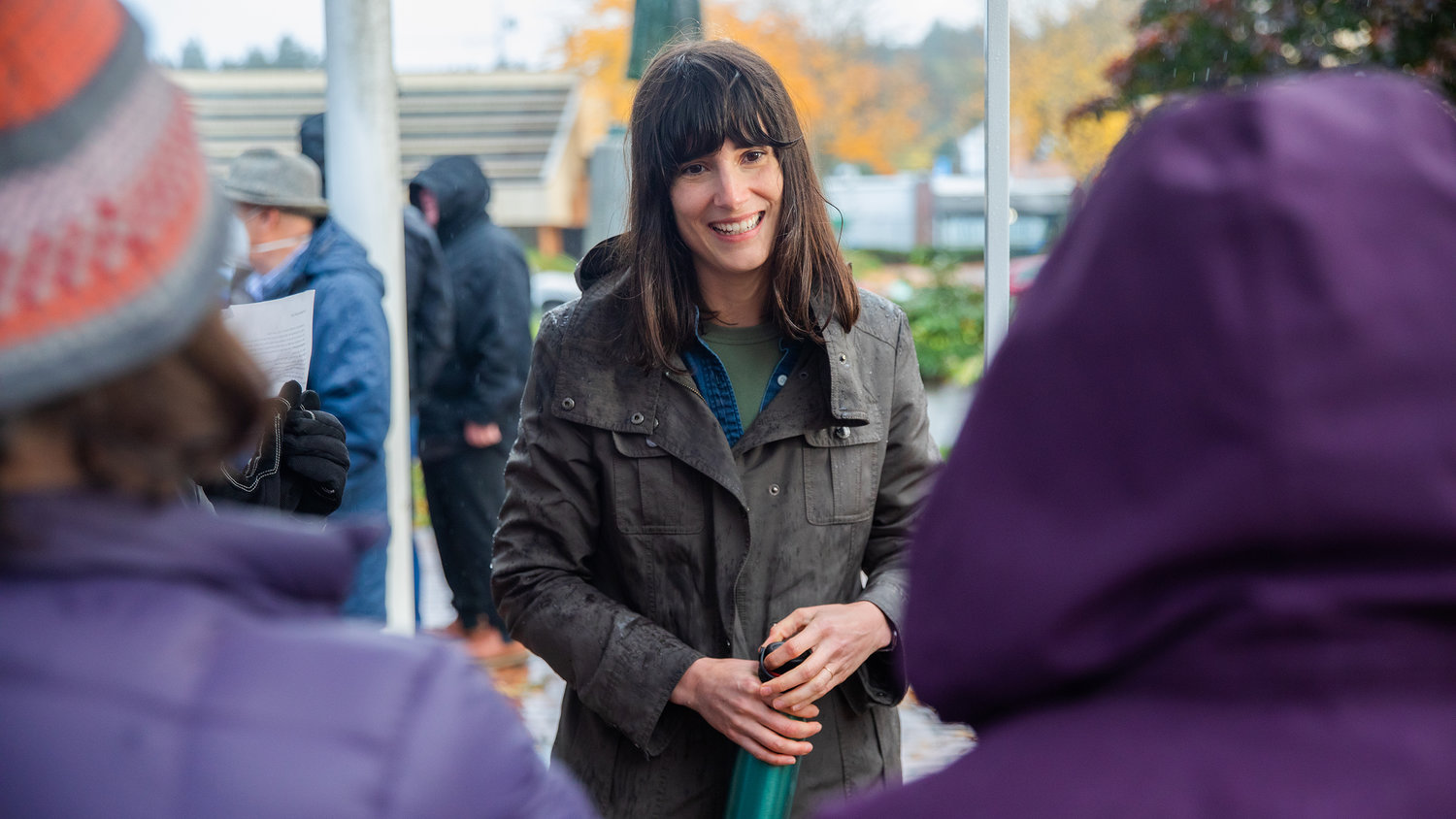 Marie Gluesenkamp Perez smiles while thanking supporters standing in the rain outside the Centralia Timberland Library.