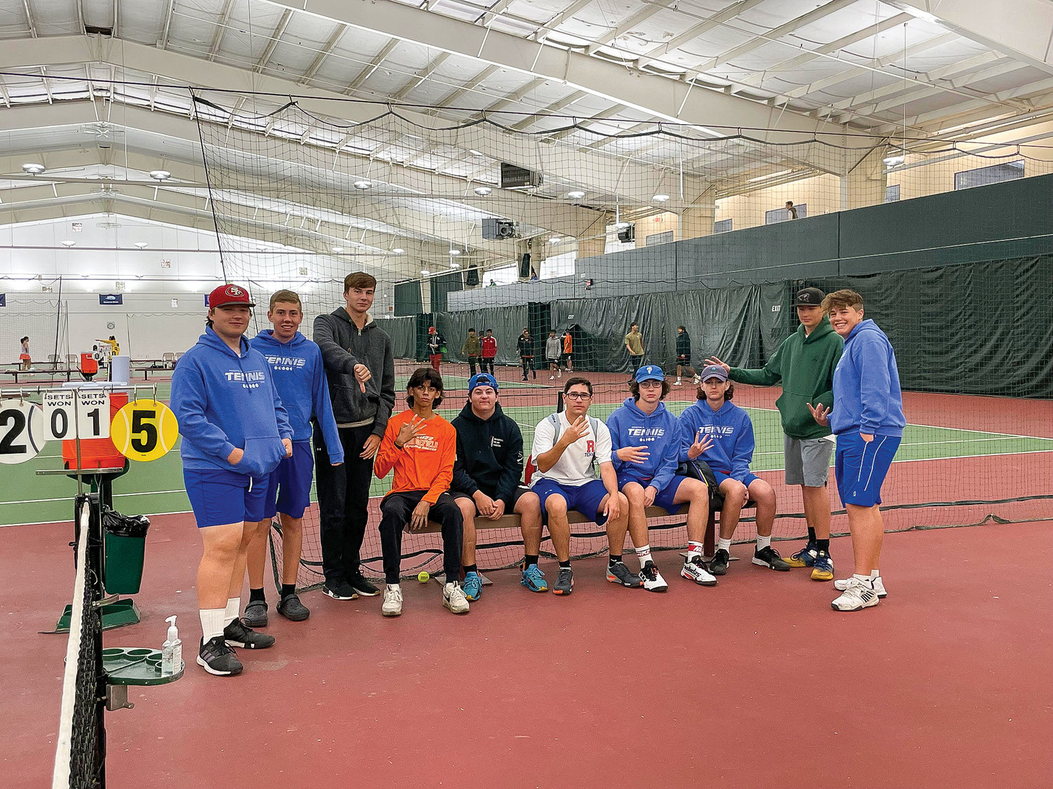 The Ridgefield High school boys tennis team gears up for 
practice indoors.