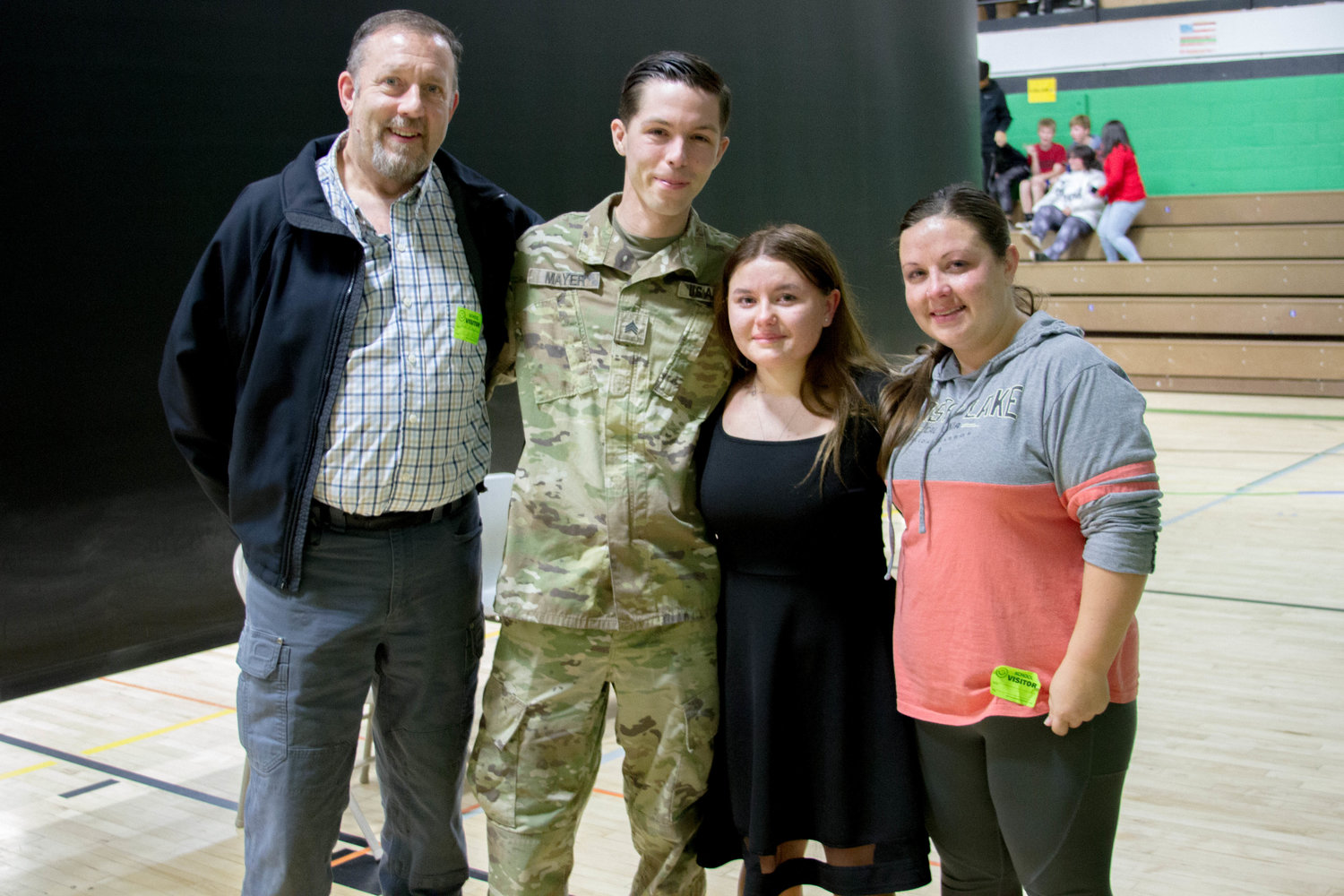 Abigail Alway stands with her uncle and mother at a Veterans Day assembly at Woodland Middle School. 