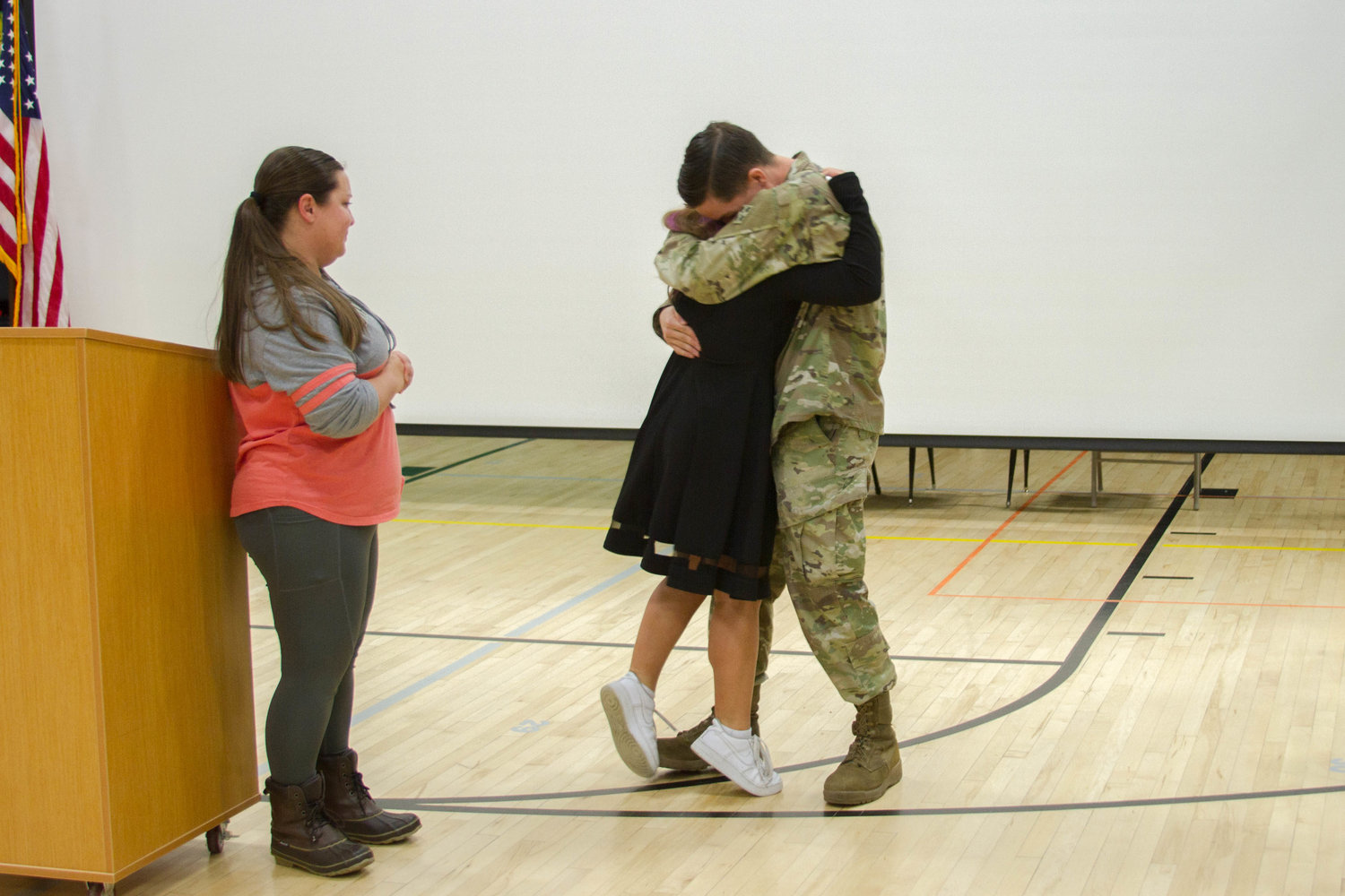 Abigail Alway, an eighth grader at Woodland Middle School, hugs her uncle who surprised her during a Veterans Day ceremony. 