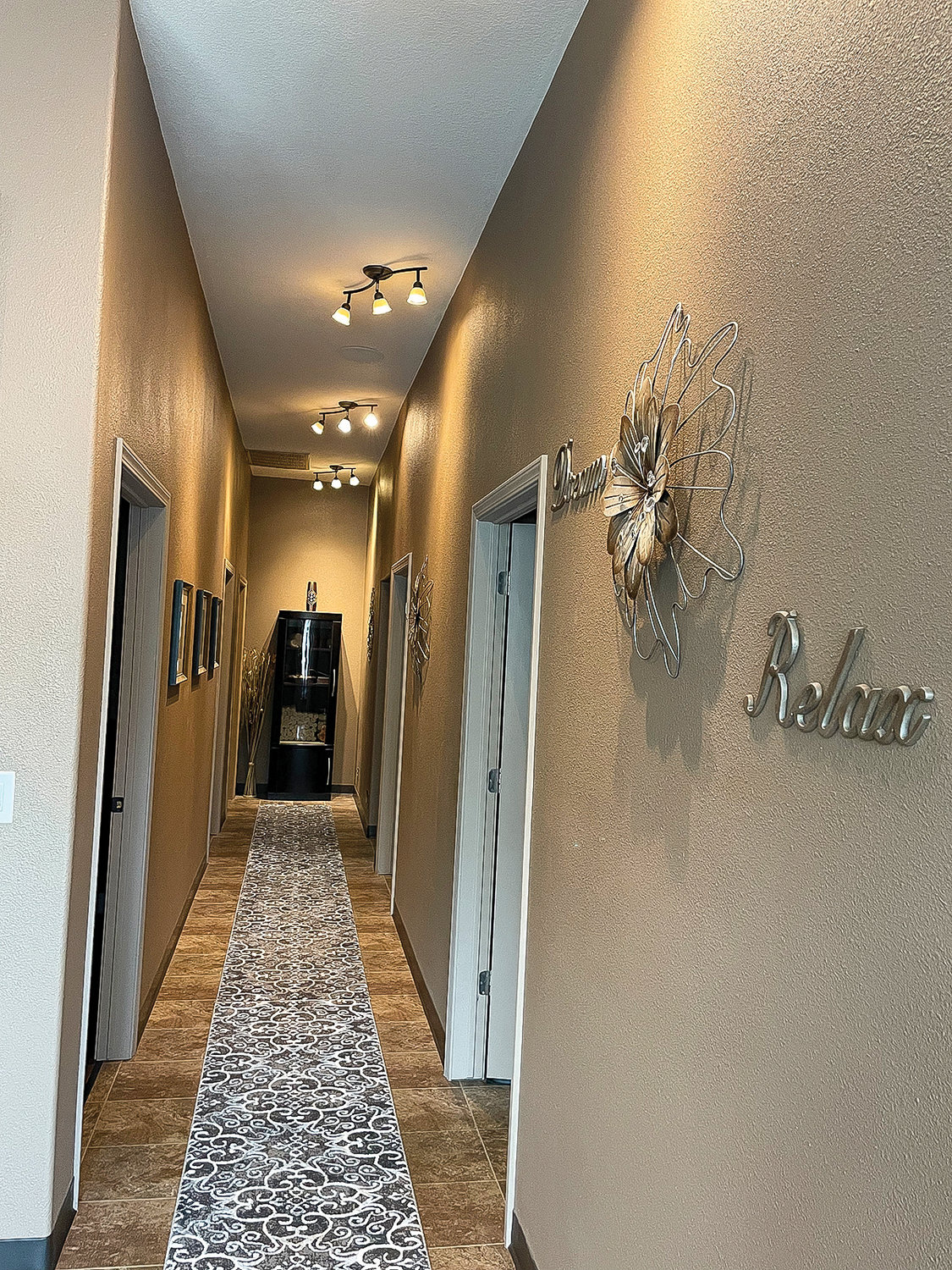A hallway leads to spa rooms at Bodywork Devine in Ridgefield.