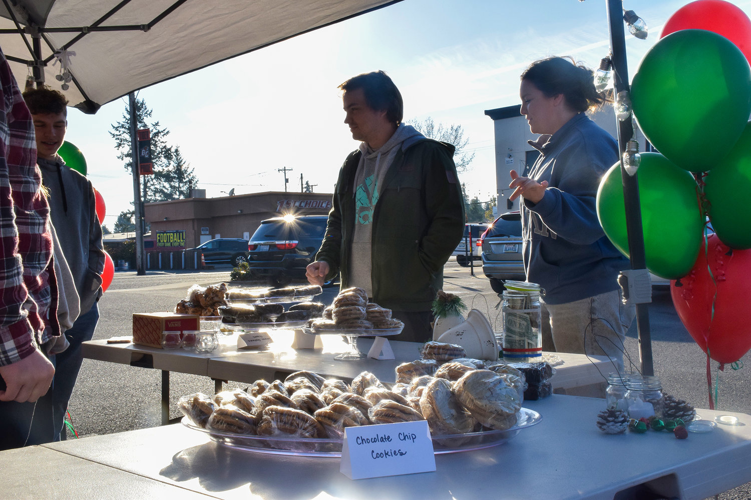 Patrons purchase baked goods during a fundraiser hosted by Battle Ground teen Hannah Boyett in the parking lot of the Margarita Factory on Nov. 20.  The money raised will help support a family in need.